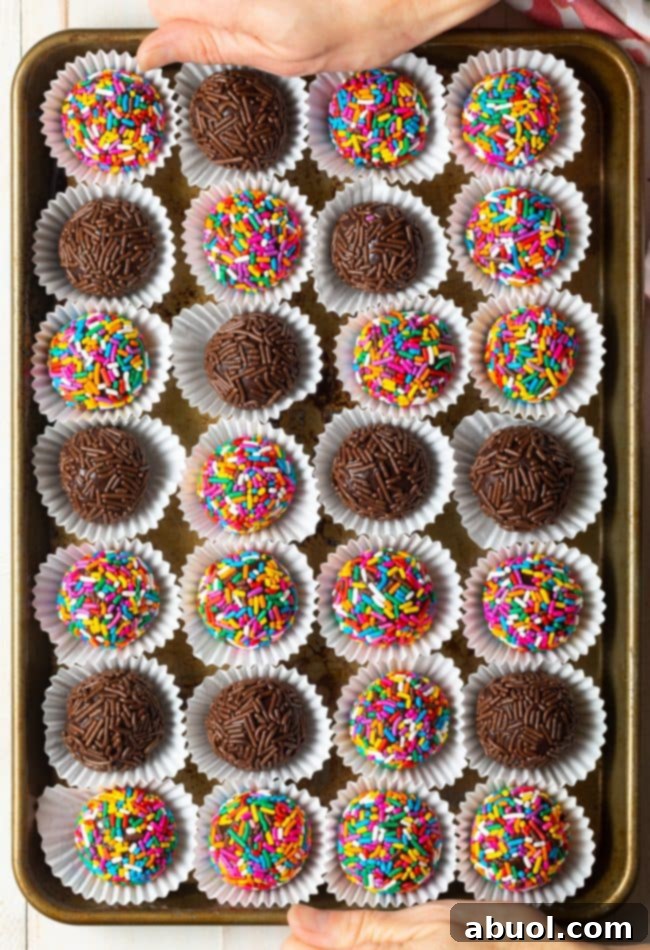 Overhead view of a tray of colorful chocolate brigadeiros.