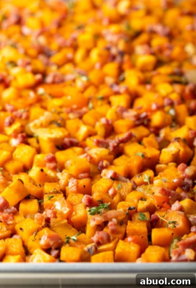 Close-up view of golden and crispy sweet potato hash browns on a baking sheet, ready to be served.