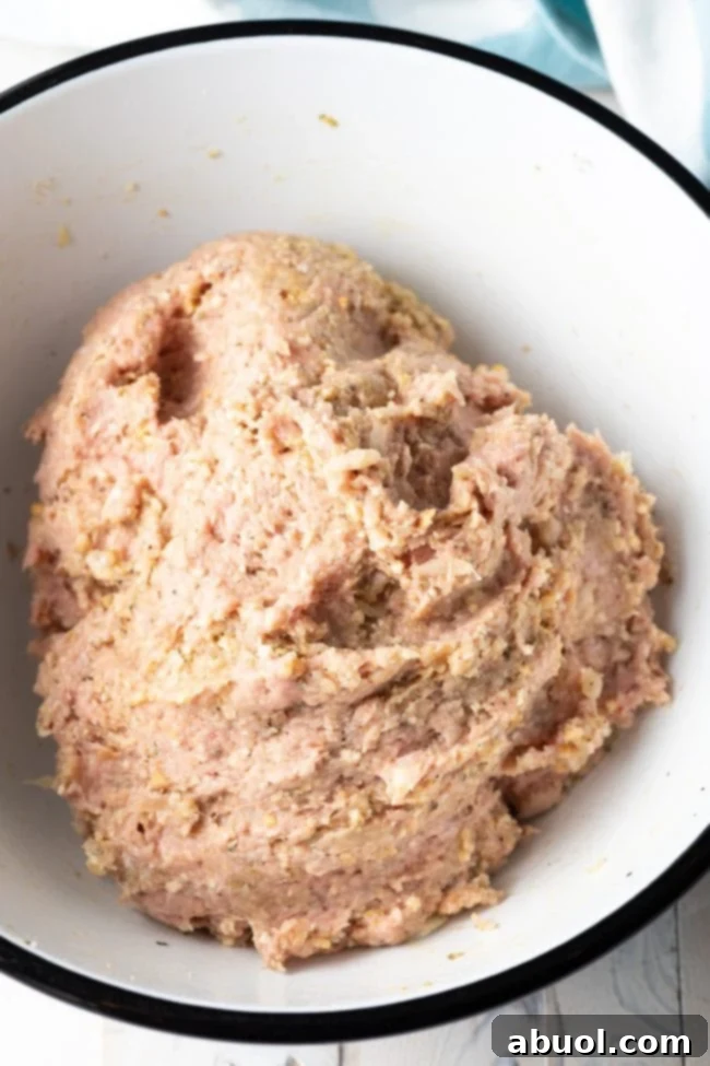 Close-up of turkey meatball mixture in a bowl, ready to be portioned and rolled.