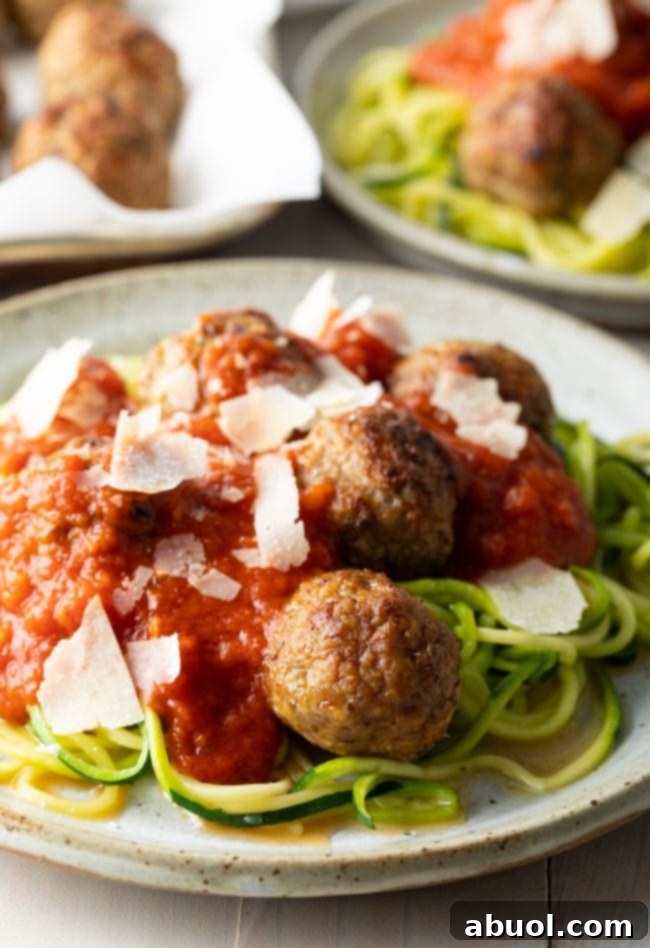 Plated healthy oven baked turkey meatballs with vibrant zoodles and a rich tomato sauce, ready to be enjoyed.