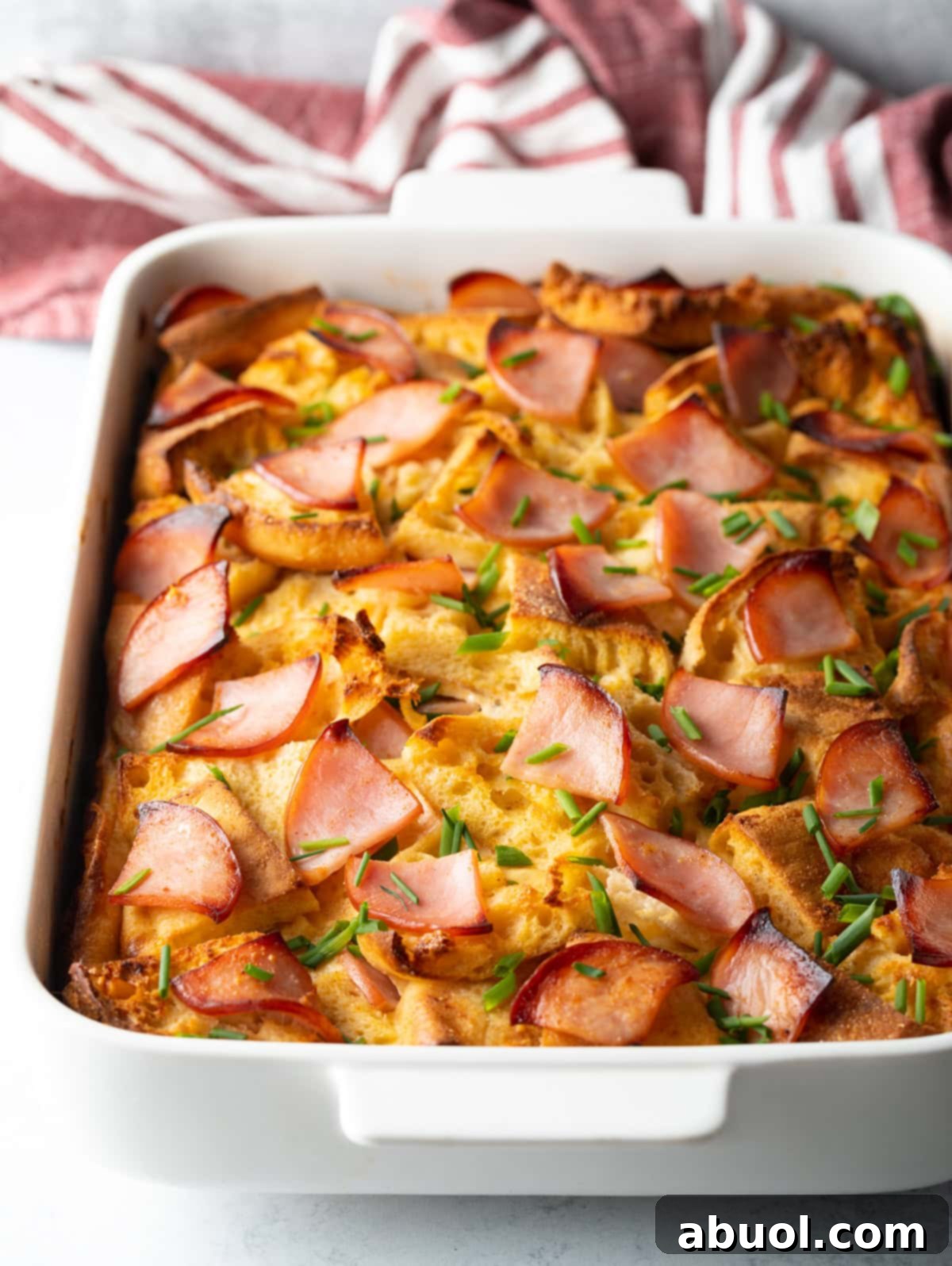 Baked Eggs Benedict Breakfast Casserole in a white baking dish