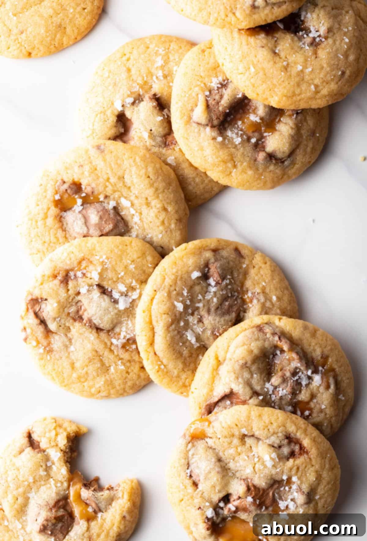 A beautifully arranged batch of Milky Way cookies with candy bars stacked artfully.