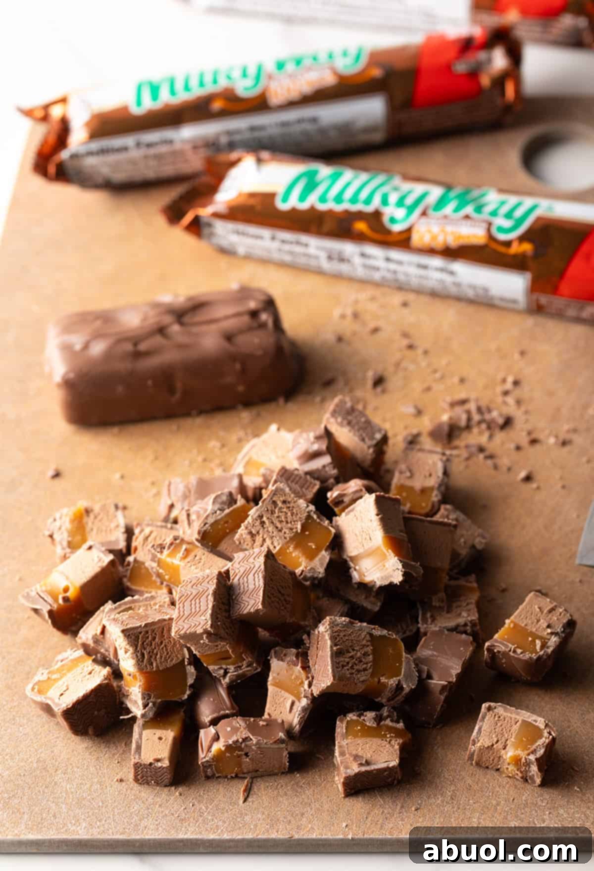 Chopped Milky Way bars on a cutting board.