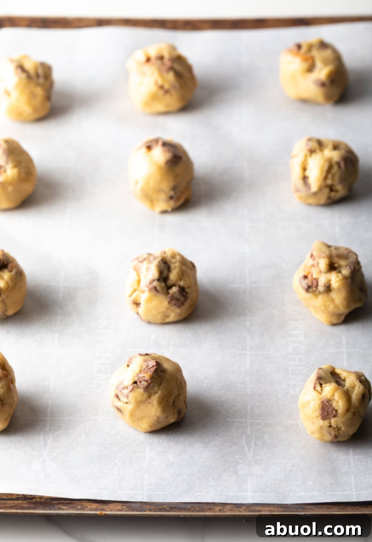 Milky Way cookie dough balls on parchment paper.