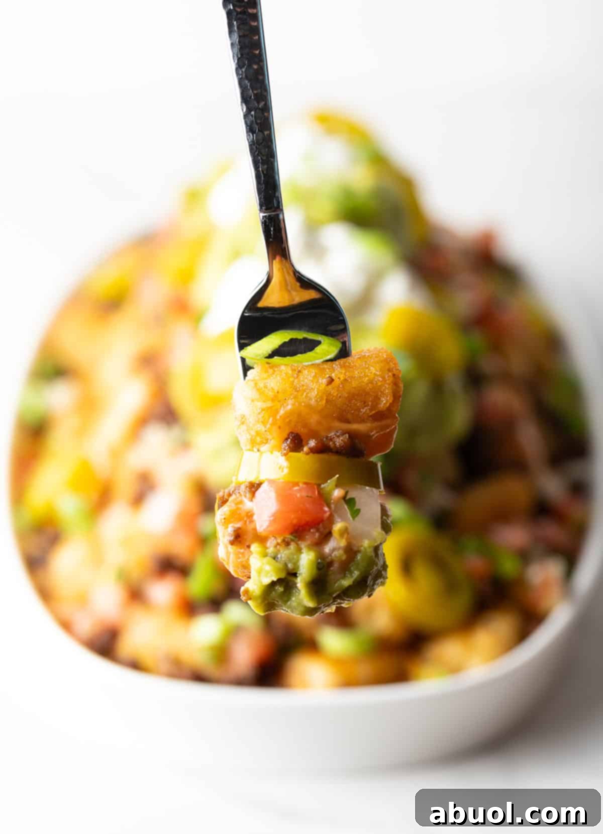 Forkful of cheesy, loaded tater tots