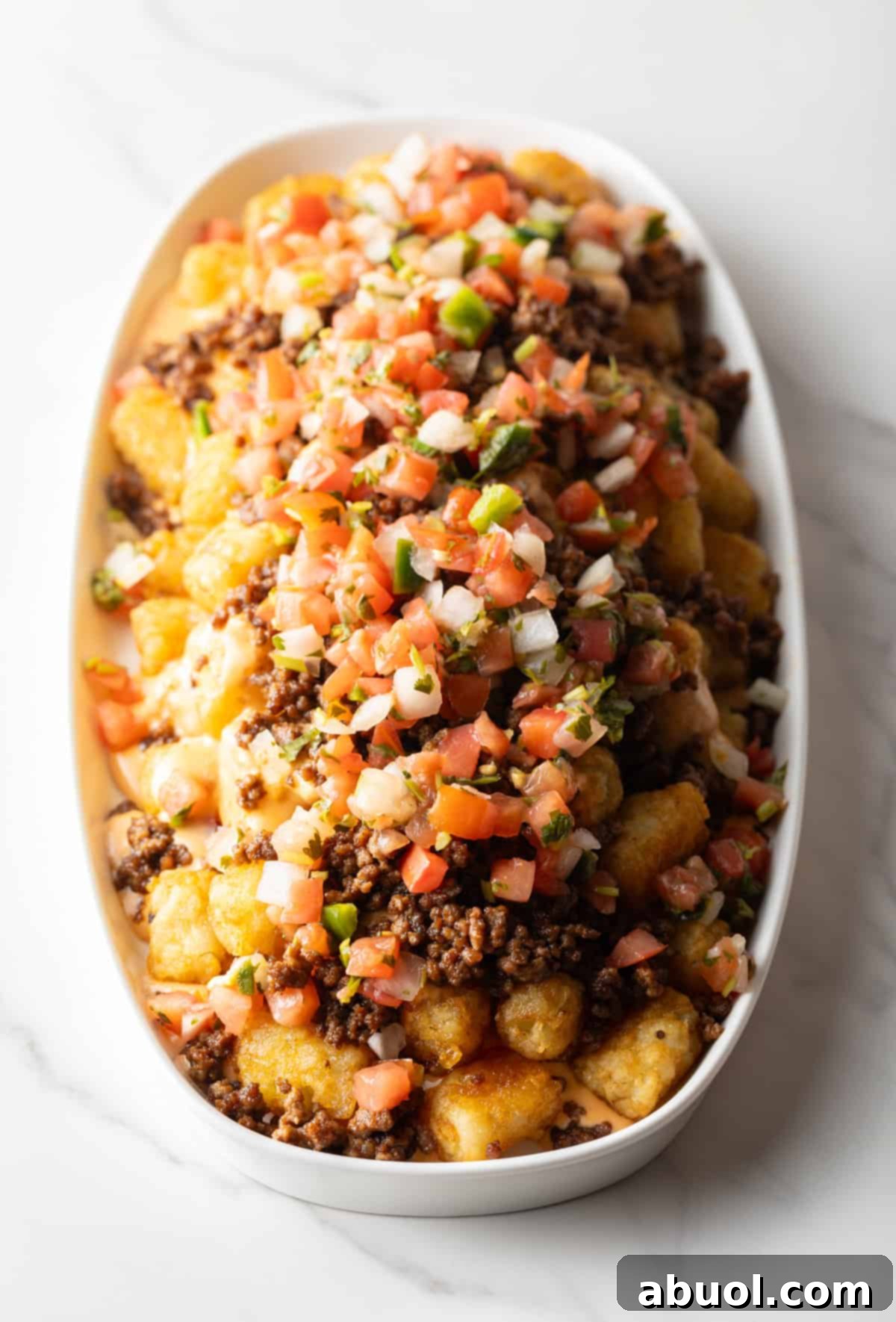 Tater tots with ground beef and pico de gallo