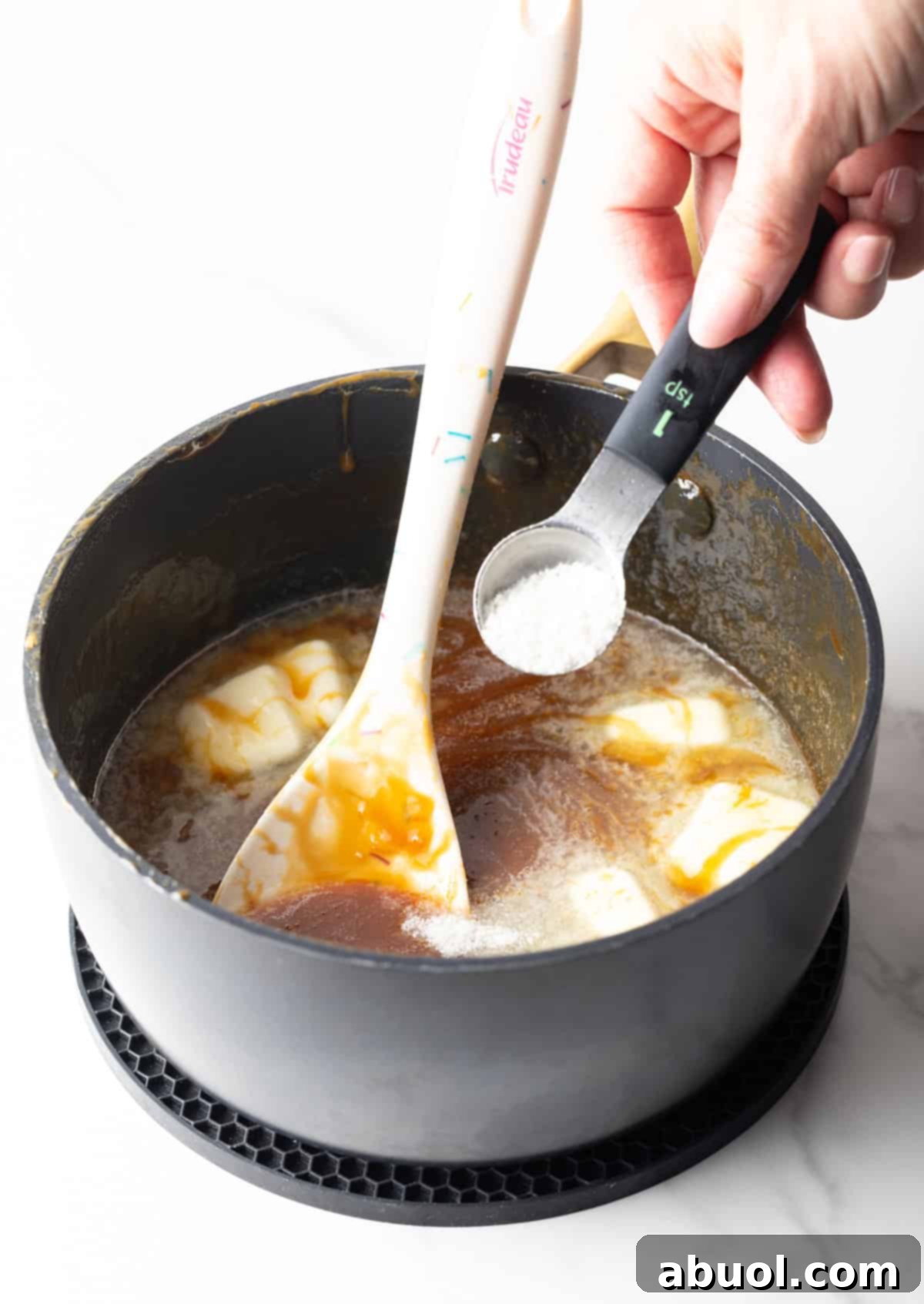 Ingredients being added to salted caramel sauce