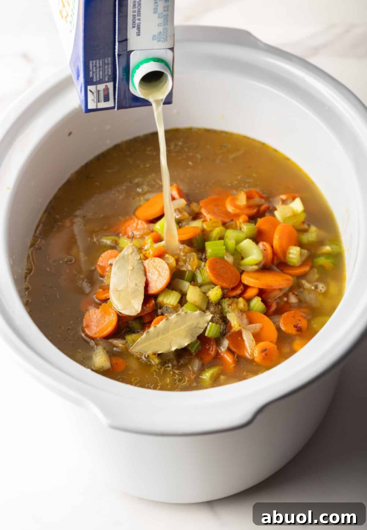 Chicken Broth Pouring into Crockpot
