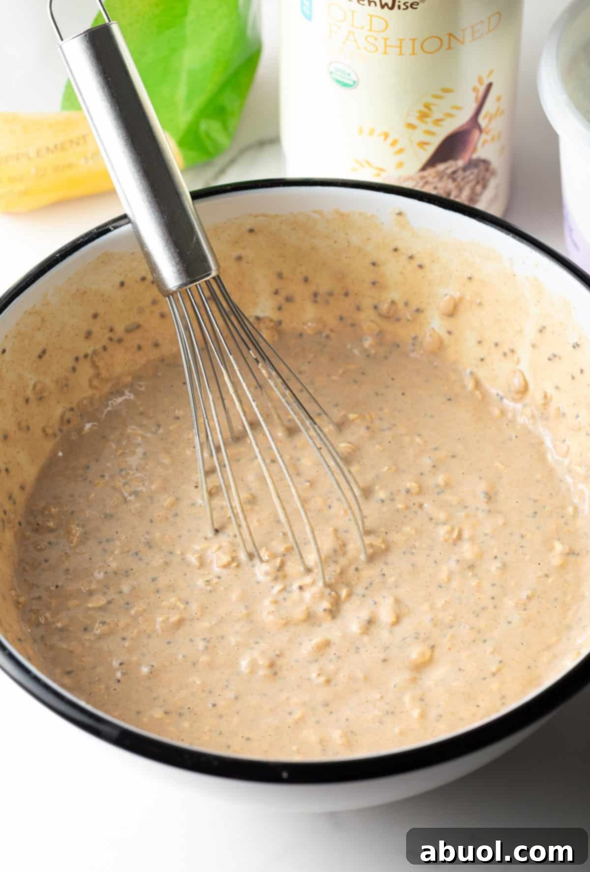 Whisk stirring ingredients for high-protein overnight oats