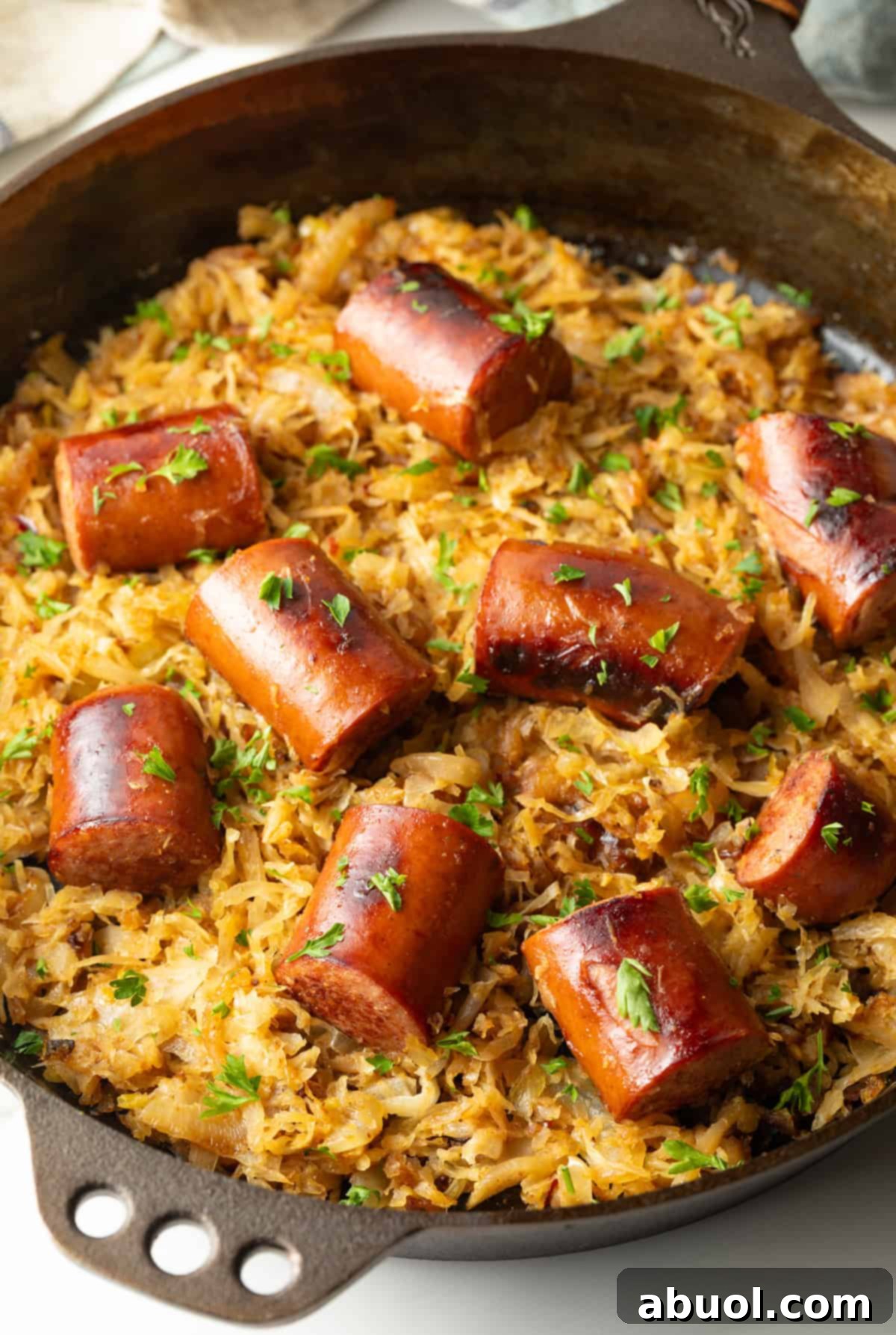 Skillet with browned sauerkraut and cooked kielbasa