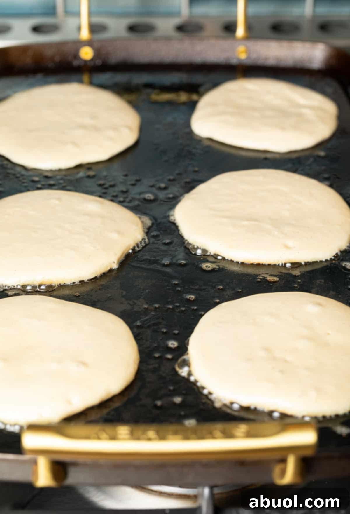 Pancakes cooking on a griddle