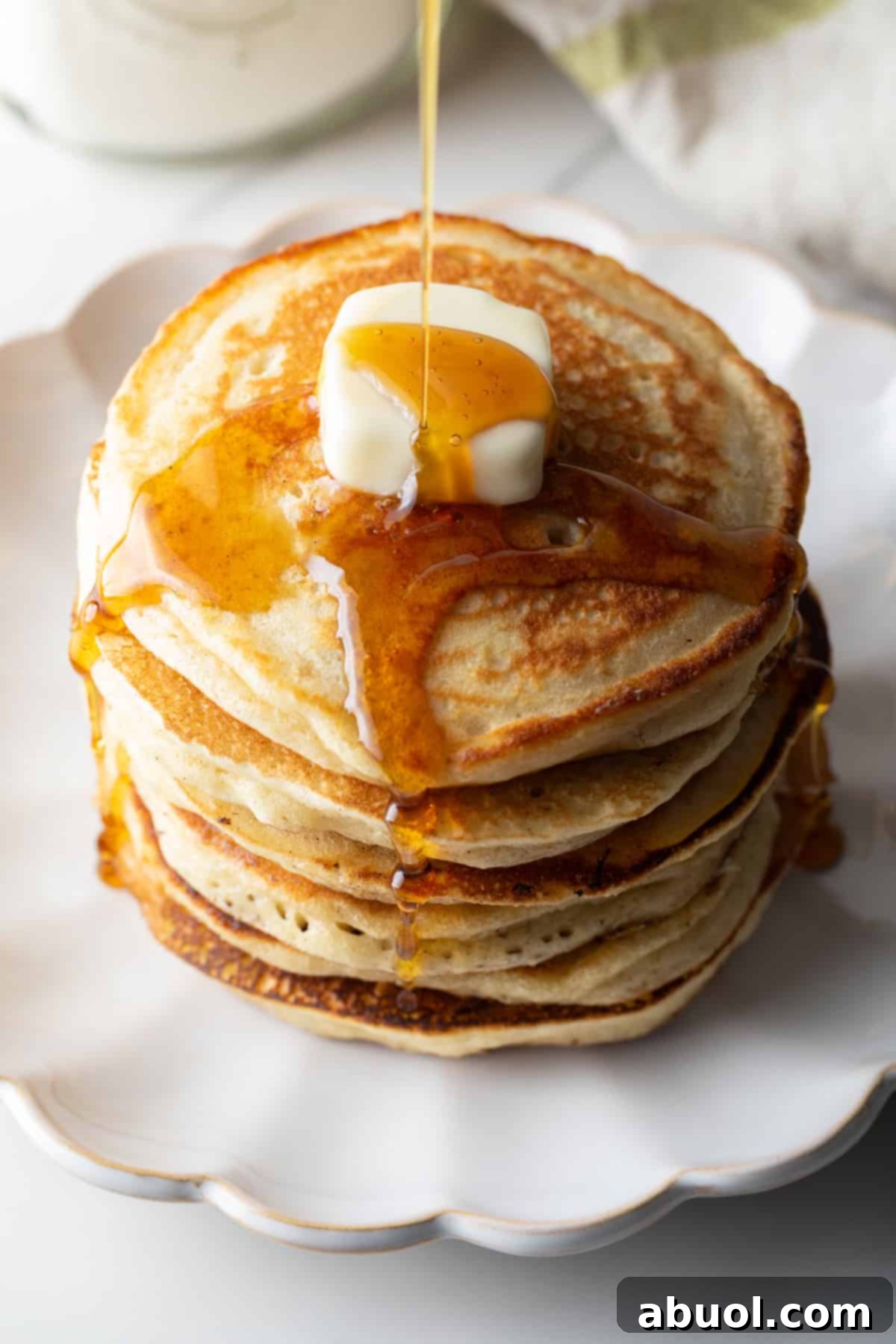 Stack of pancakes with butter and syrup