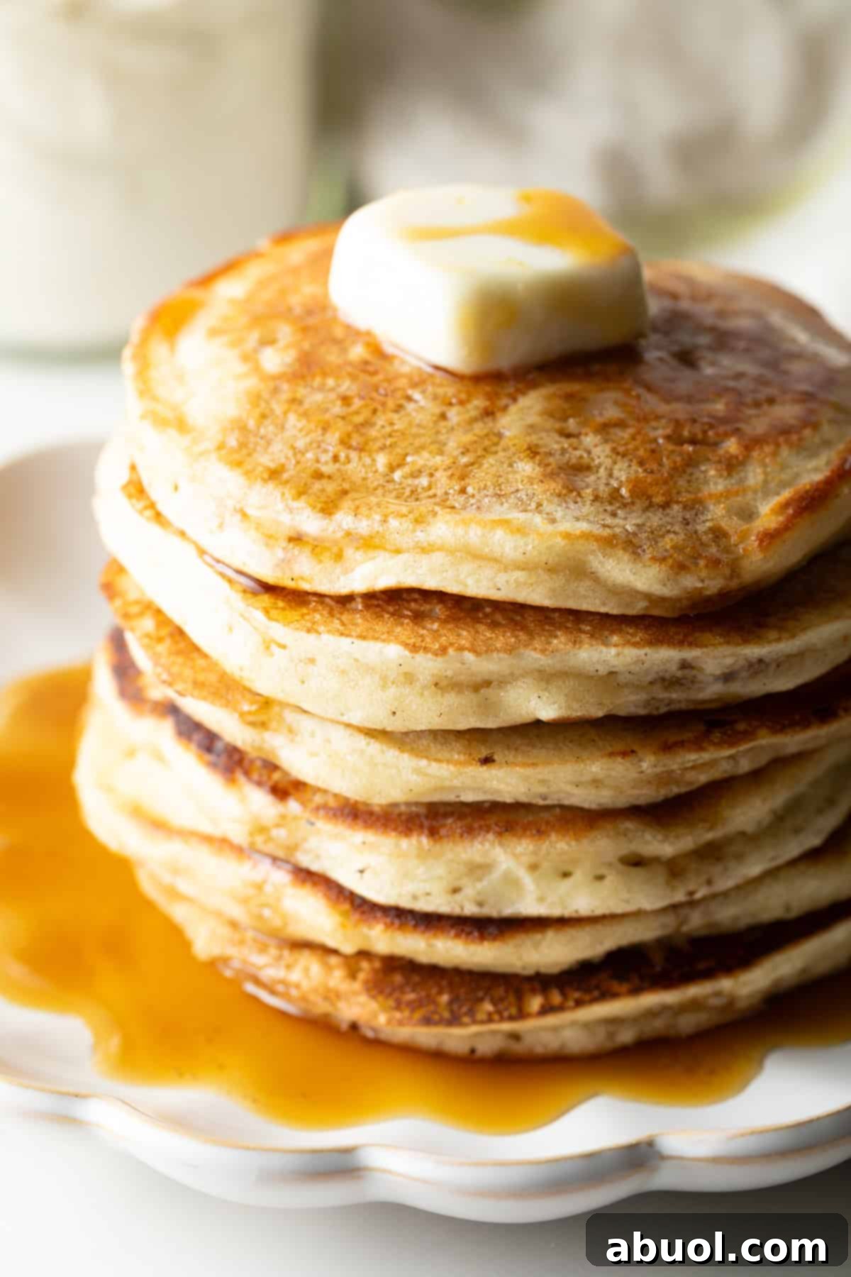 Stack of pancakes with butter and syrup