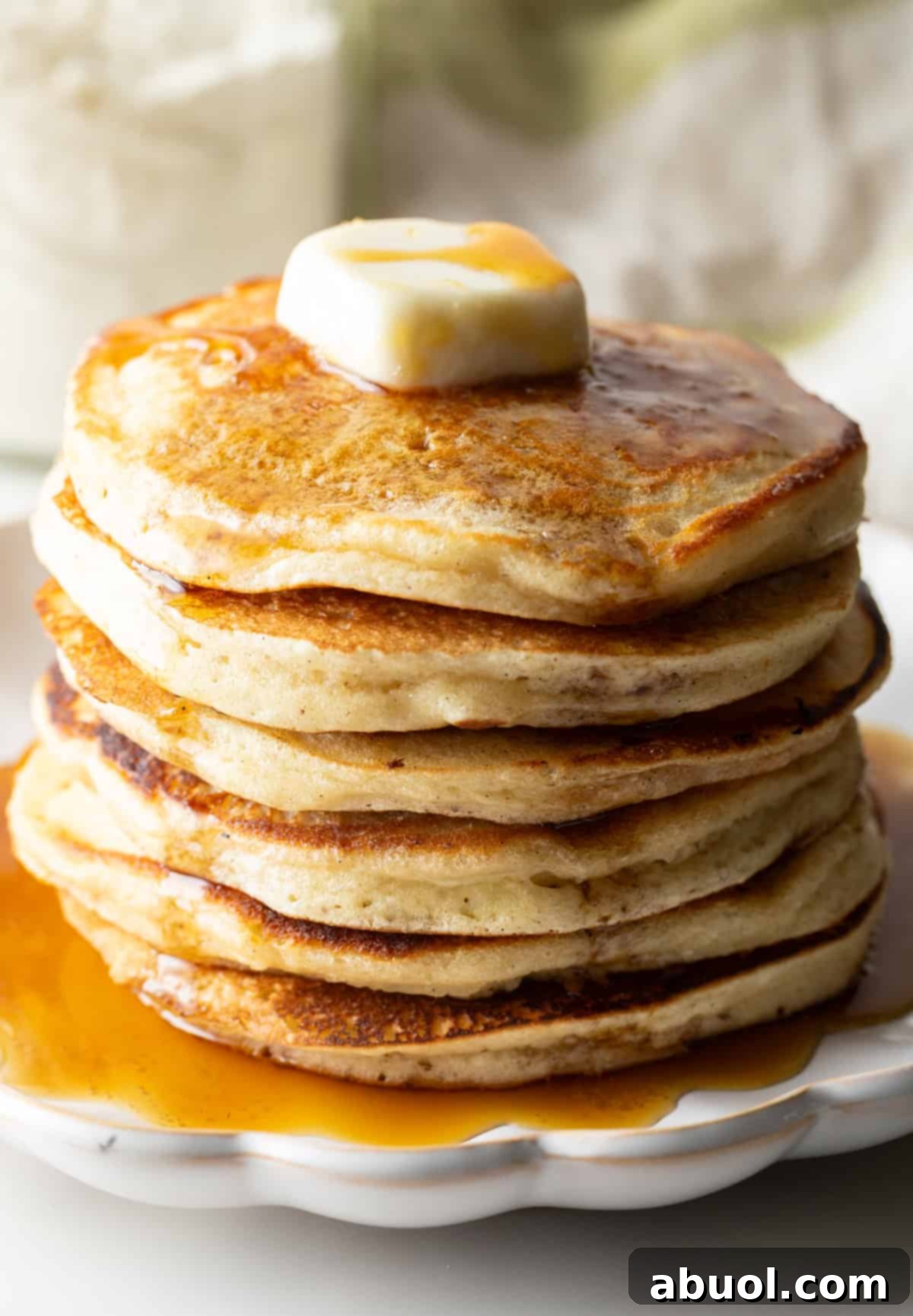 Stack of pancakes with butter and syrup