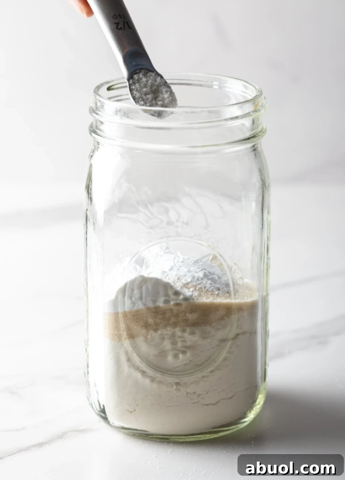Measuring baking soda into pancake mix
