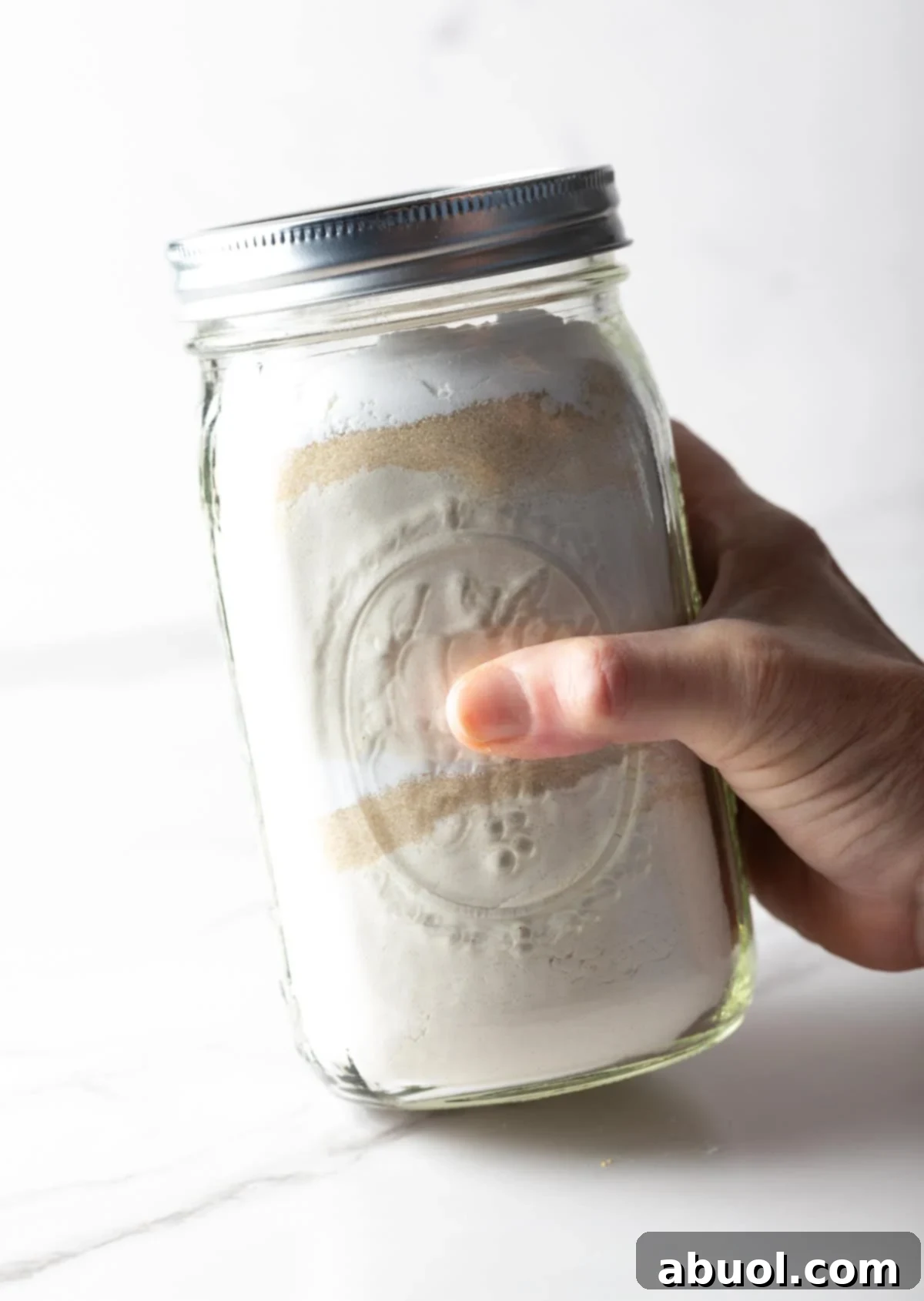 Shaking pancake mix in a jar