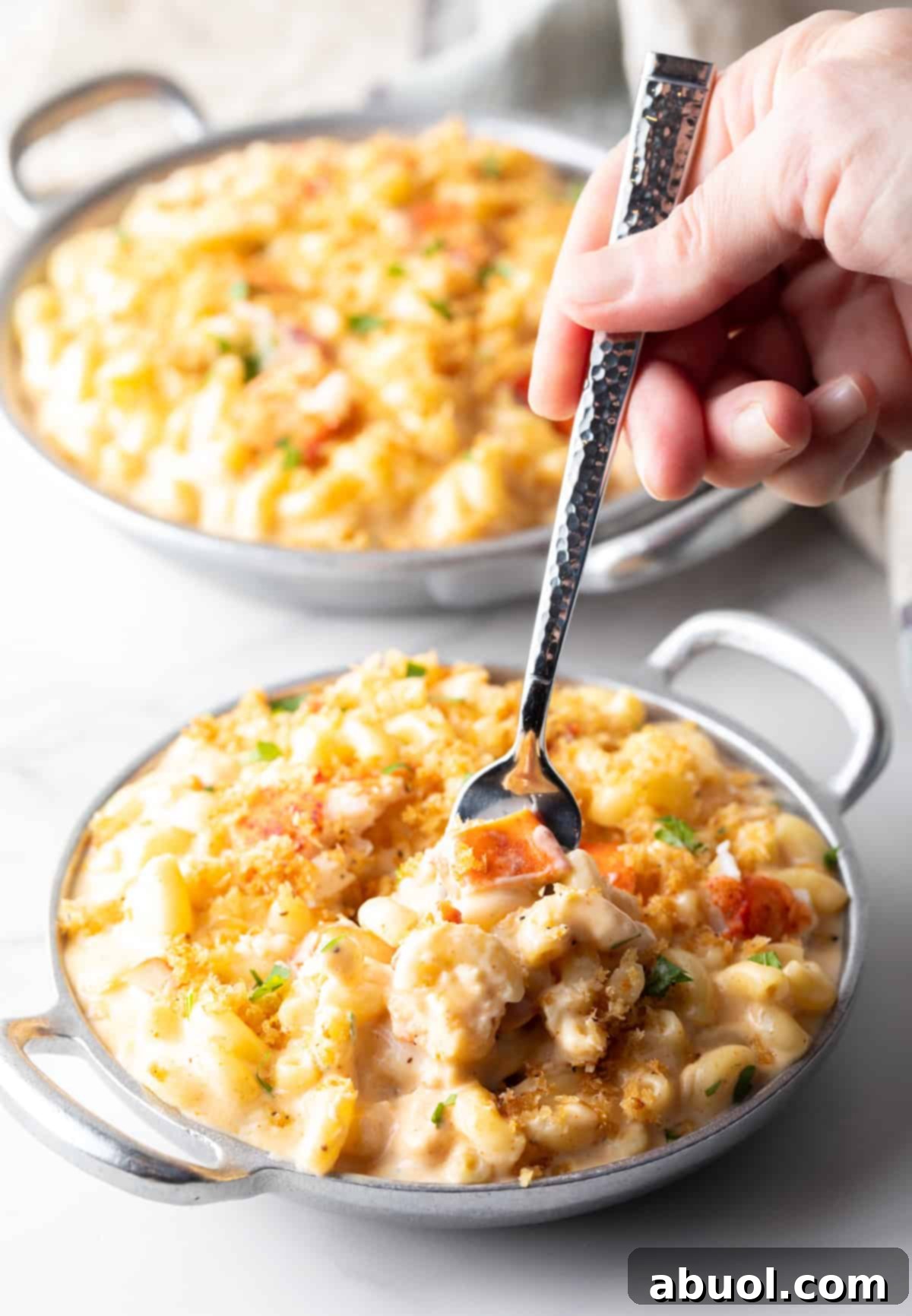 Fork taking a bite of lobster mac and cheese