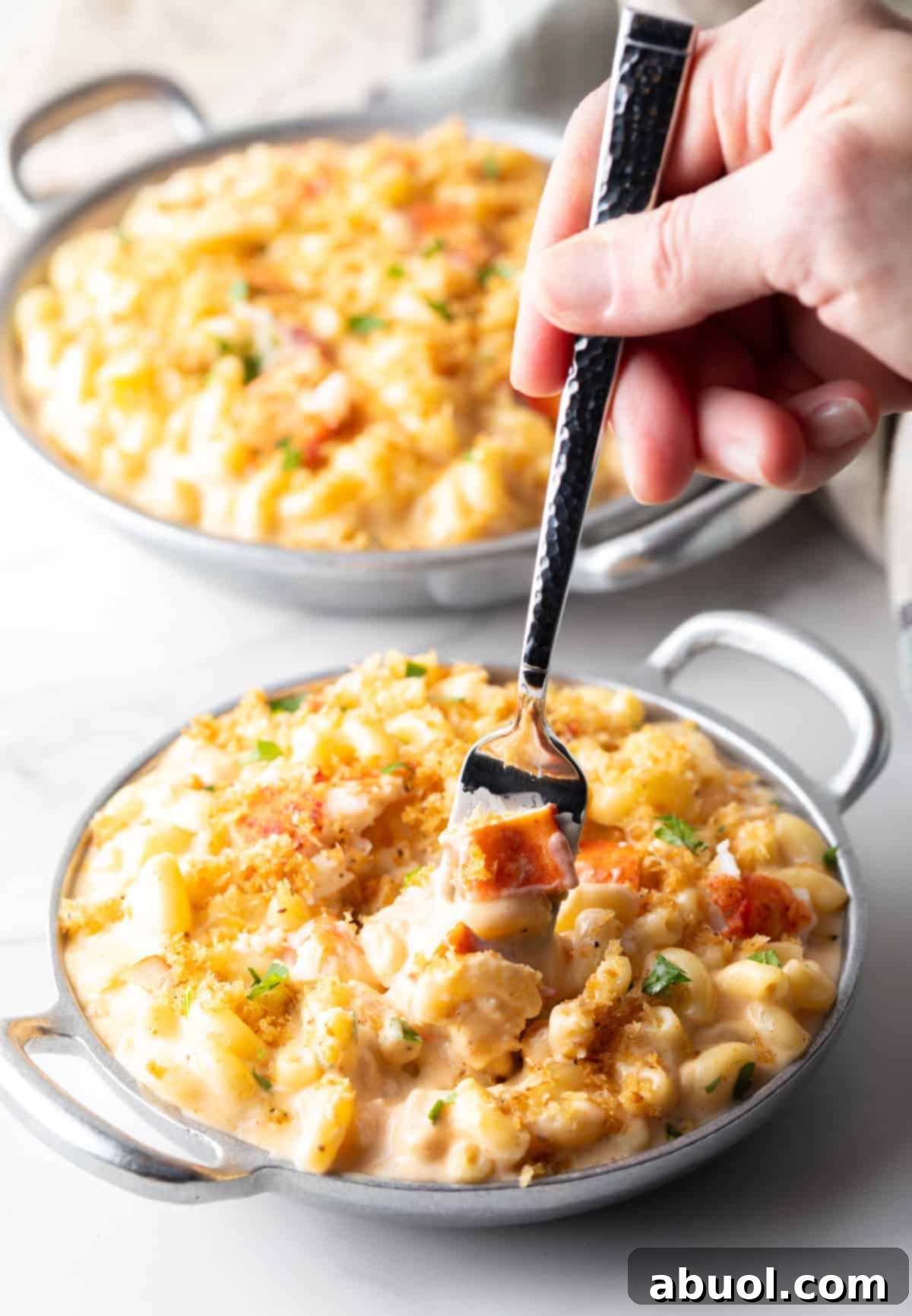 Fork taking a bite of lobster mac and cheese