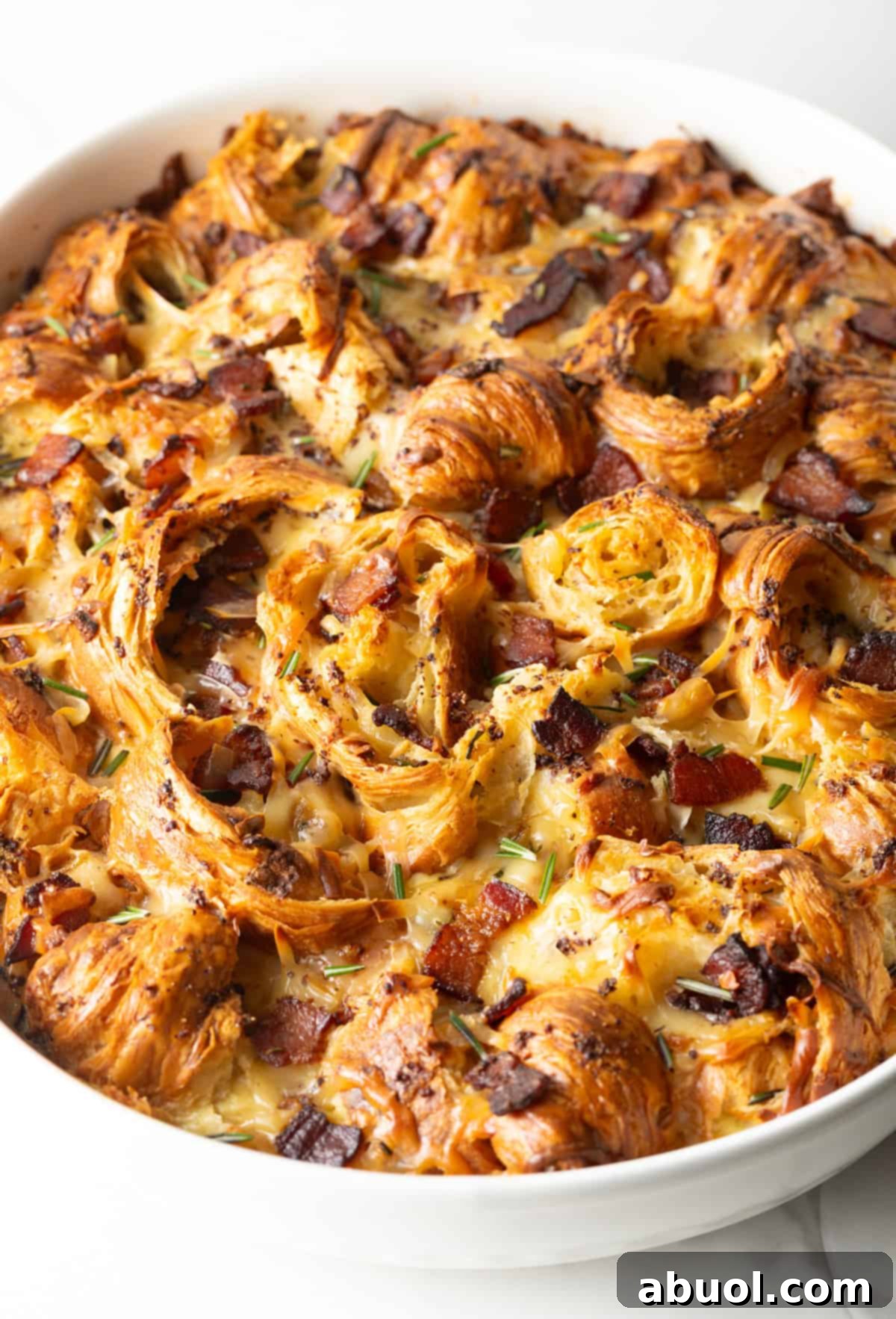 Overhead shot of croissant casserole recipe in a white baking dish, fresh from the oven.
