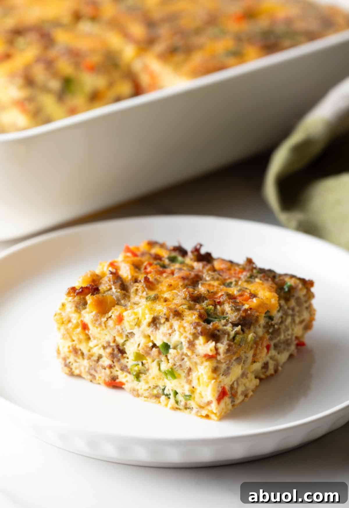 Slice of sausage breakfast casserole on a white plate