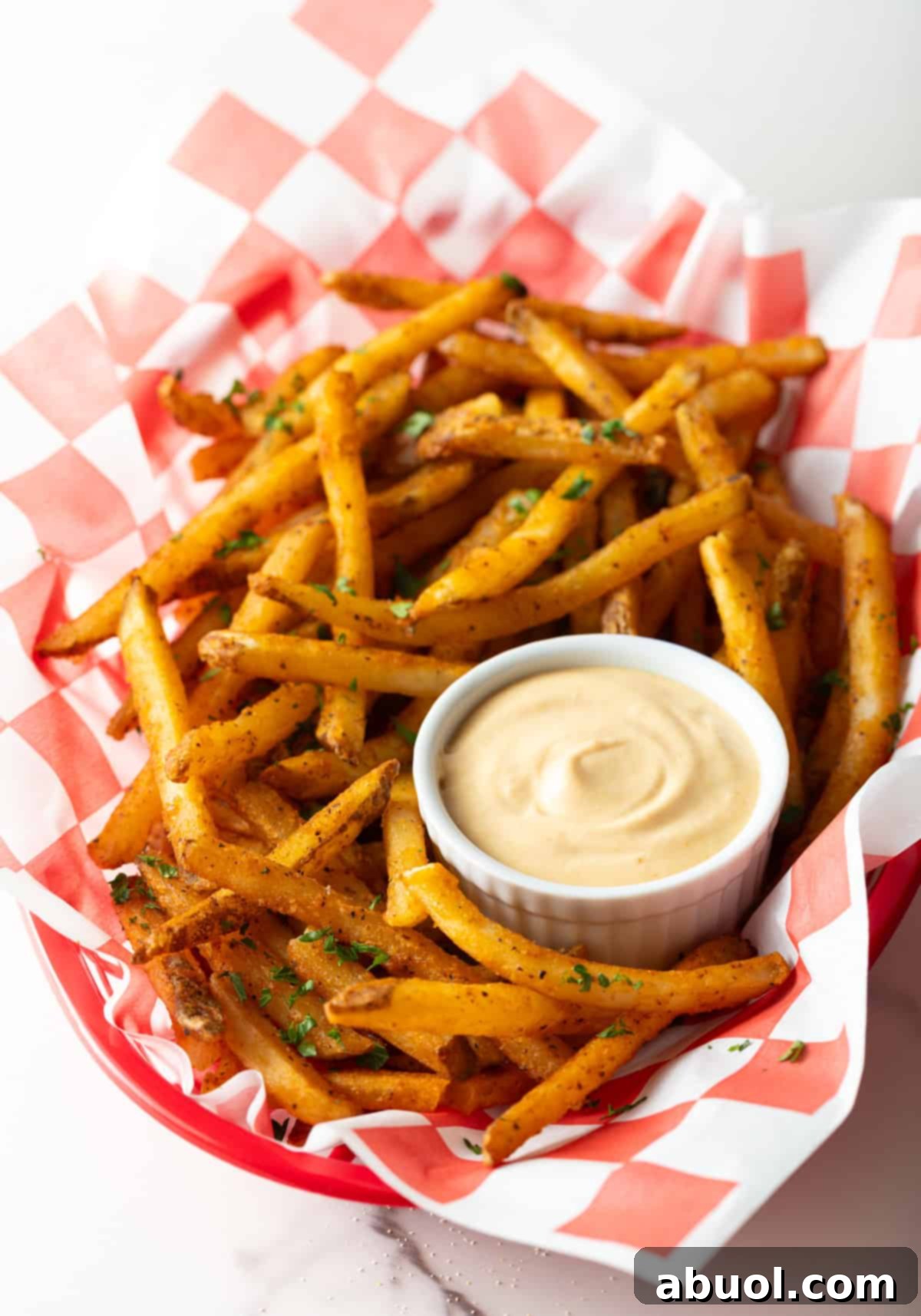 French fries surrounding a ramekin of homemade dipping sauce.
