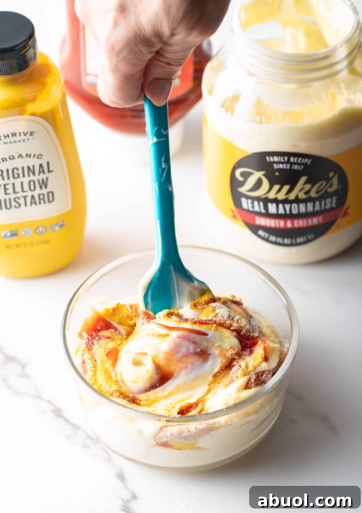 Mixing sauce ingredients in a bowl.
