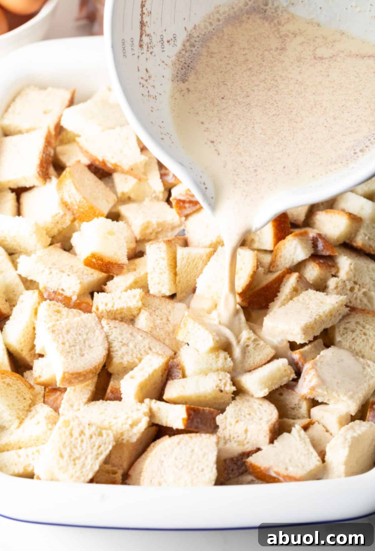 Pouring Cream Mixture over Bread