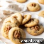 Chocolate chip walnut cookies lined up in a circle on a white plate.