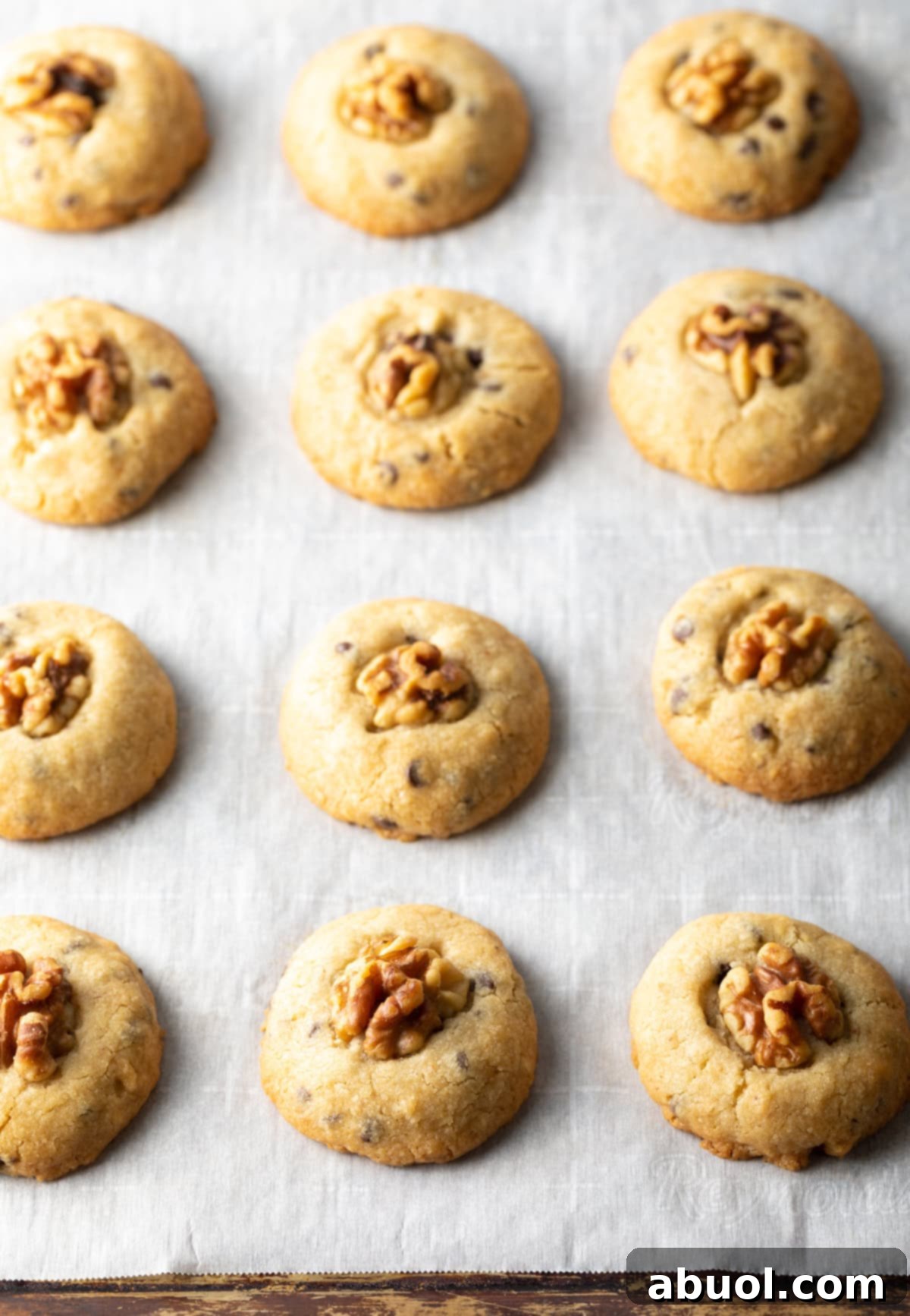 Chocolate chip walnut cookies on a baking sheet.