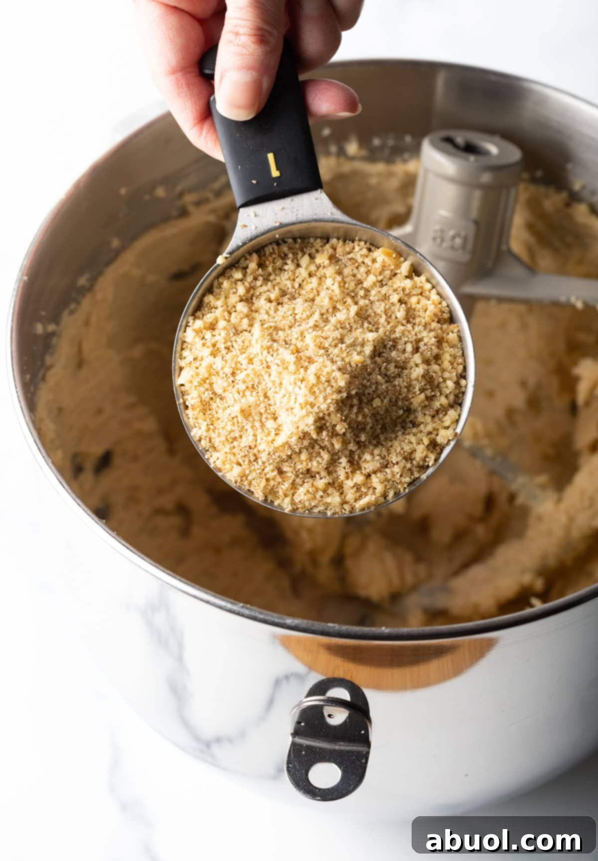 Ground walnuts being added to the cookie mix.