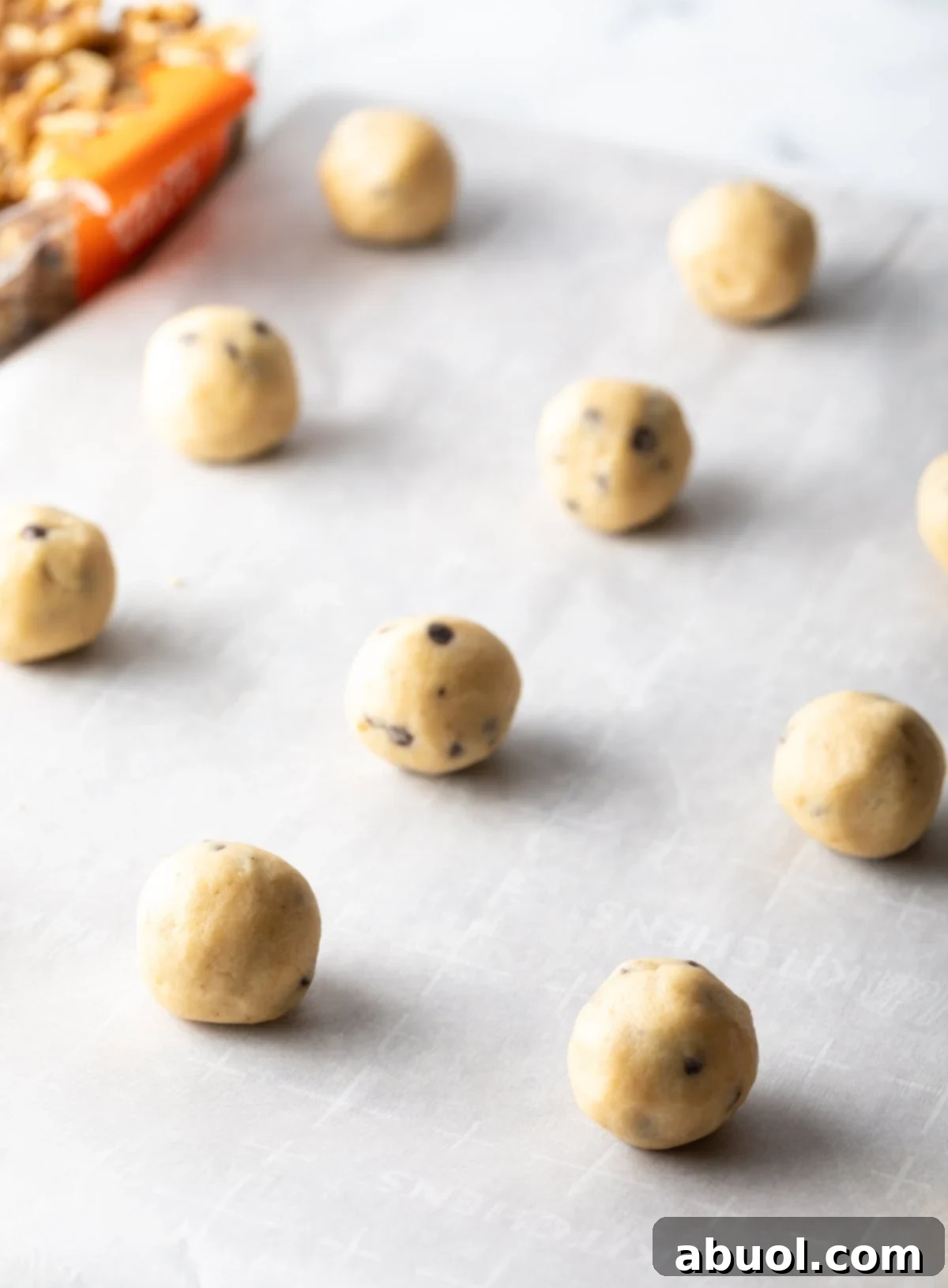 Cookie dough balls on a baking sheet.