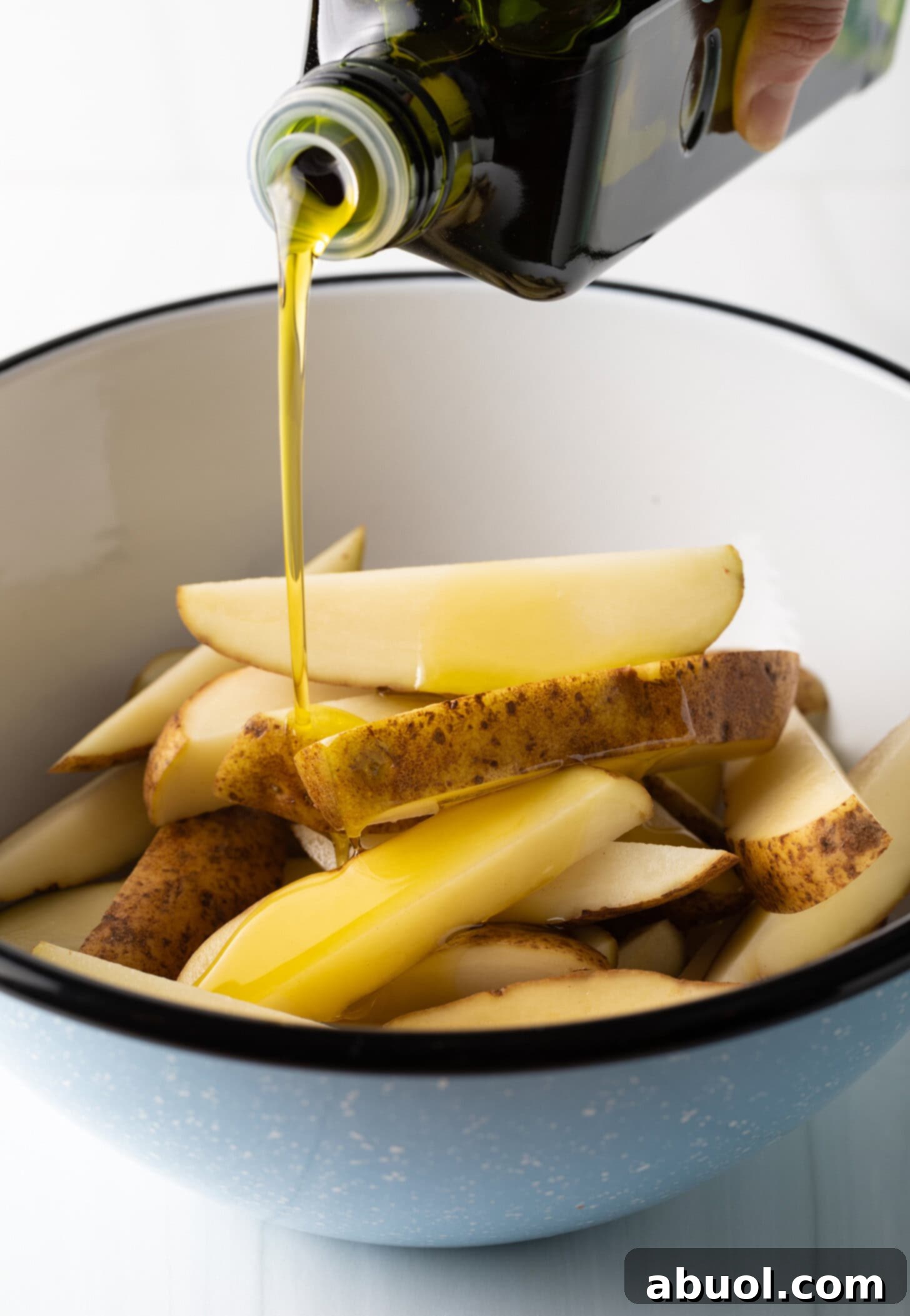 Air Fryer Potato Bites 7 Adding Olive Oil to Potato Wedges