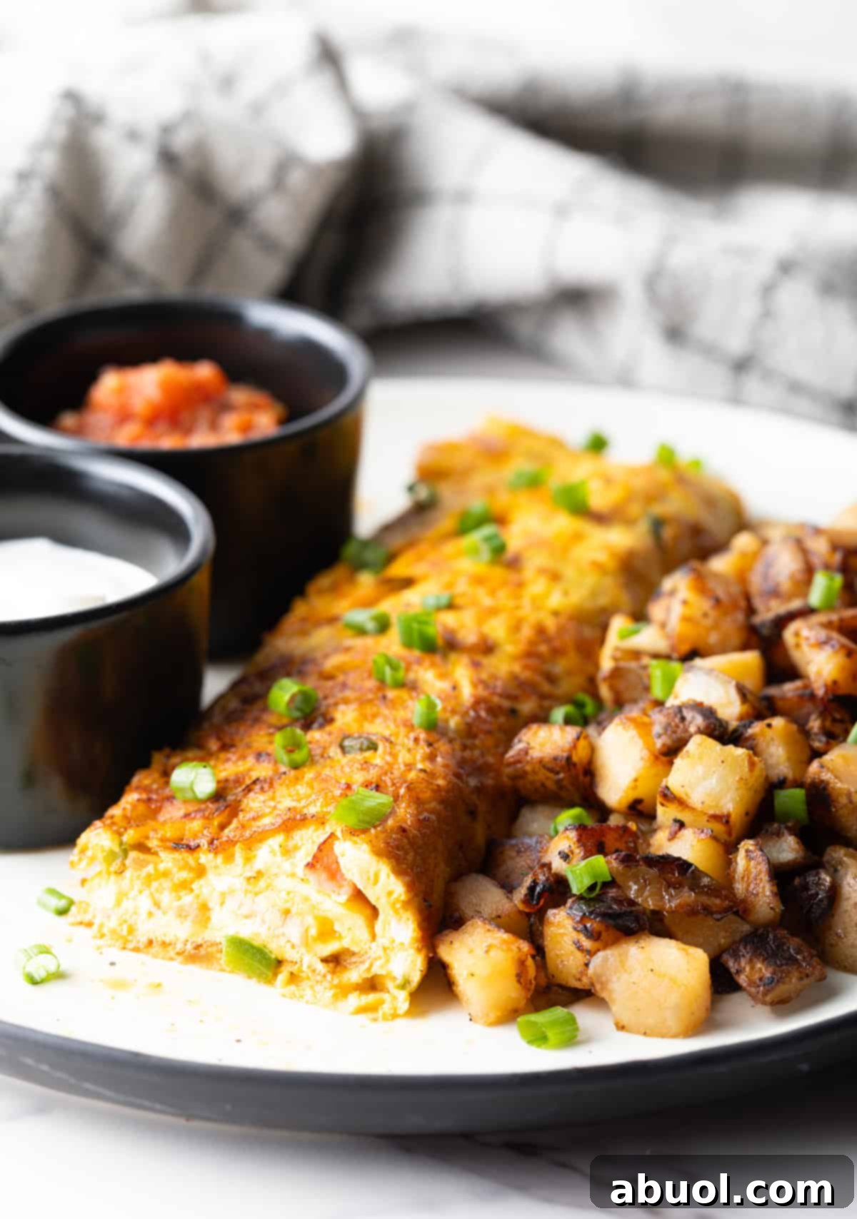 A Denver omelette recipe with a slice taken out, showing you the inside of the omelette.