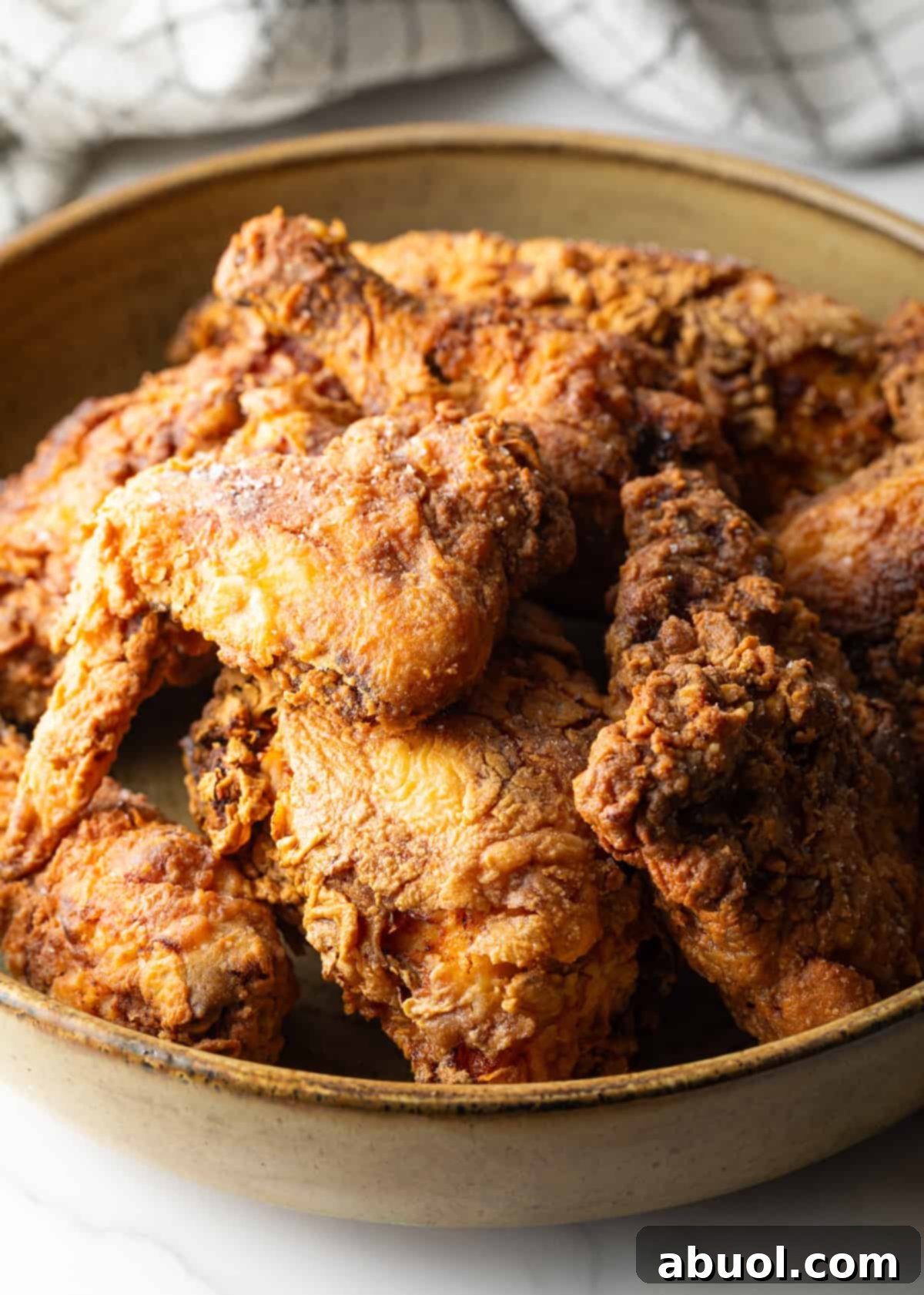 Southern Cast Iron Fried Chicken 2 Crispy homemade southern fried chicken pieces in a bowl, showcasing the golden-brown crust.