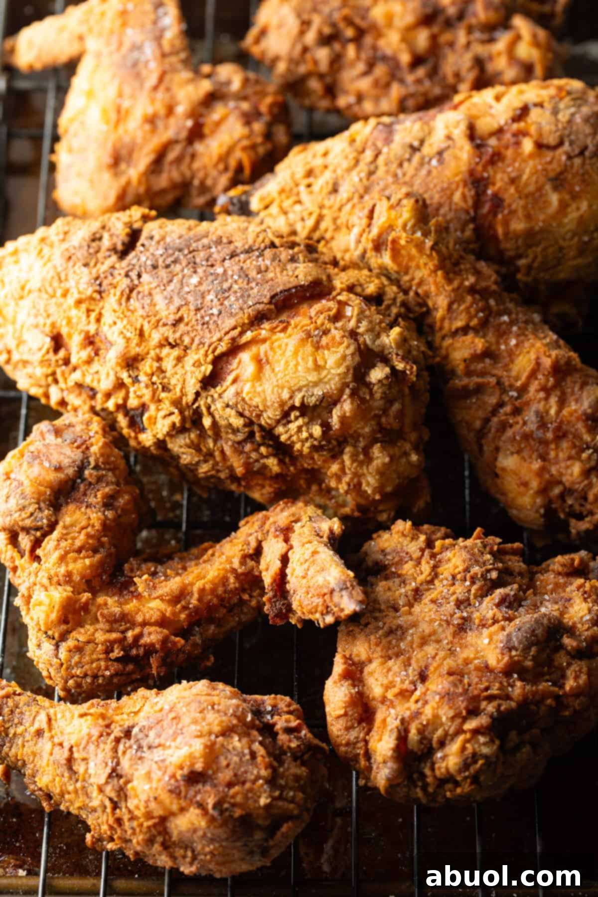 Southern Cast Iron Fried Chicken 3 Crispy southern fried chicken cooked in a cast iron skillet draining on a roasting tray, ready to be served.