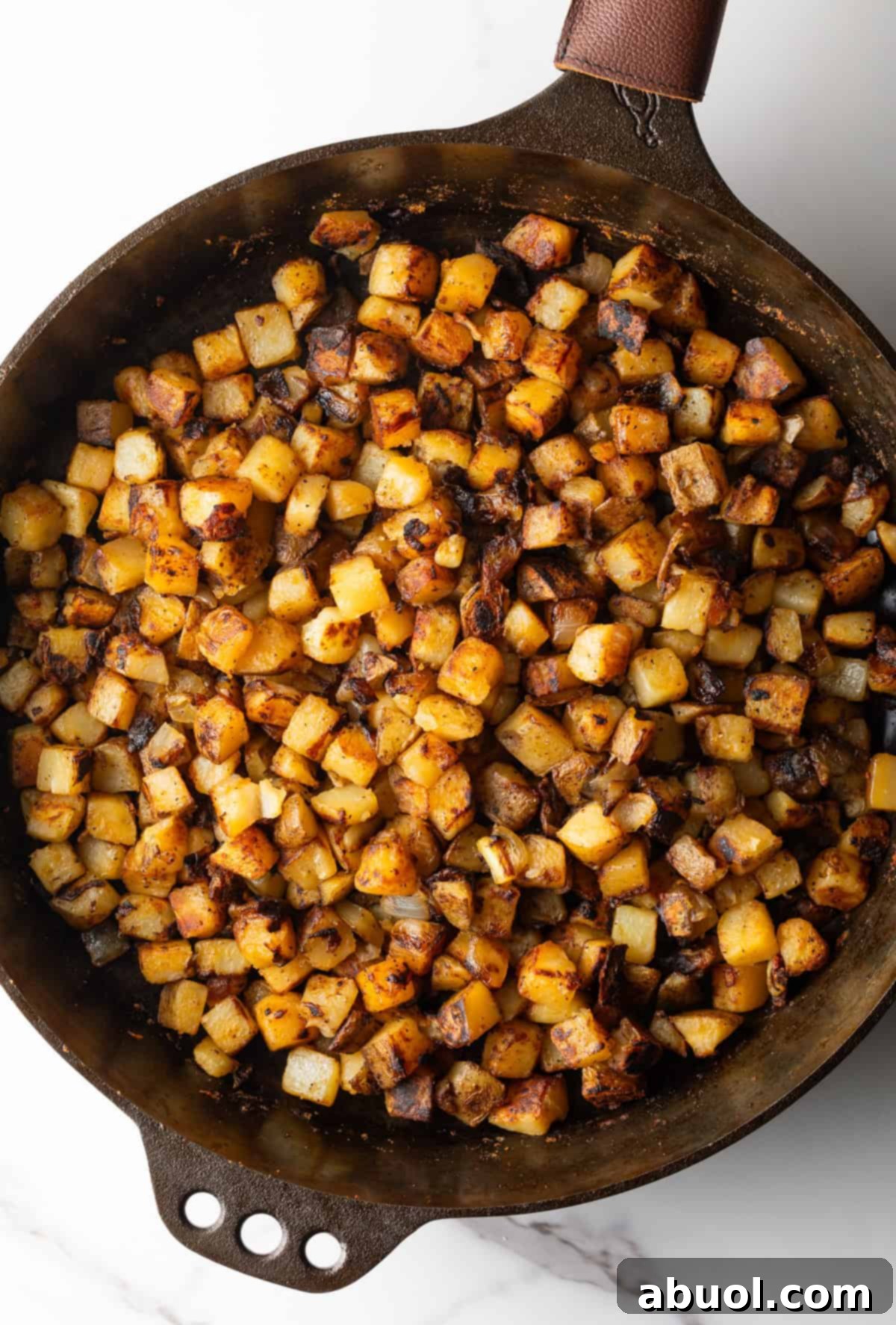 Golden Pan Fried Potatoes 8 A skillet of crispy breakfast potatoes, perfectly browned and ready to serve.