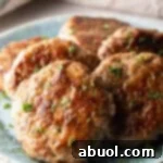 Slices of an easy homemade breakfast sausage recipe lined up in a circle on a blue plate.