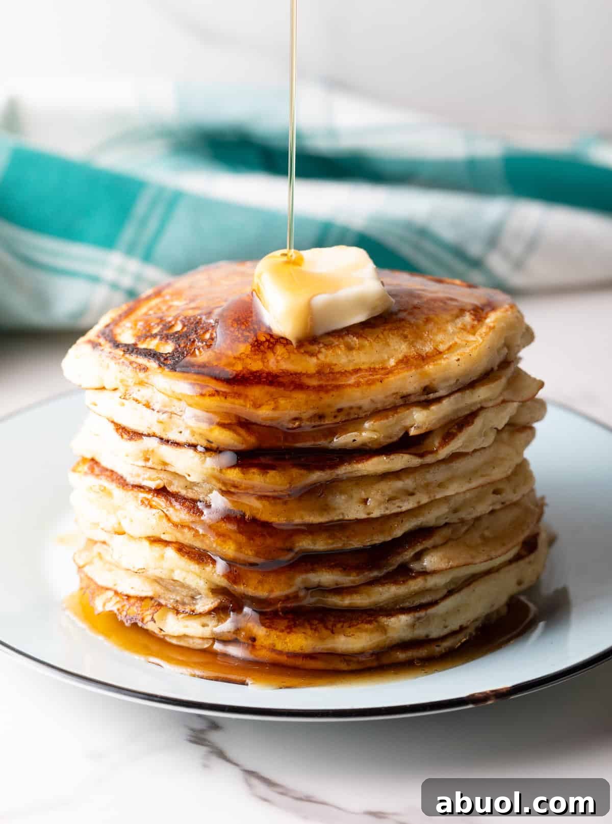 hotcakes with maple syrup poured on top