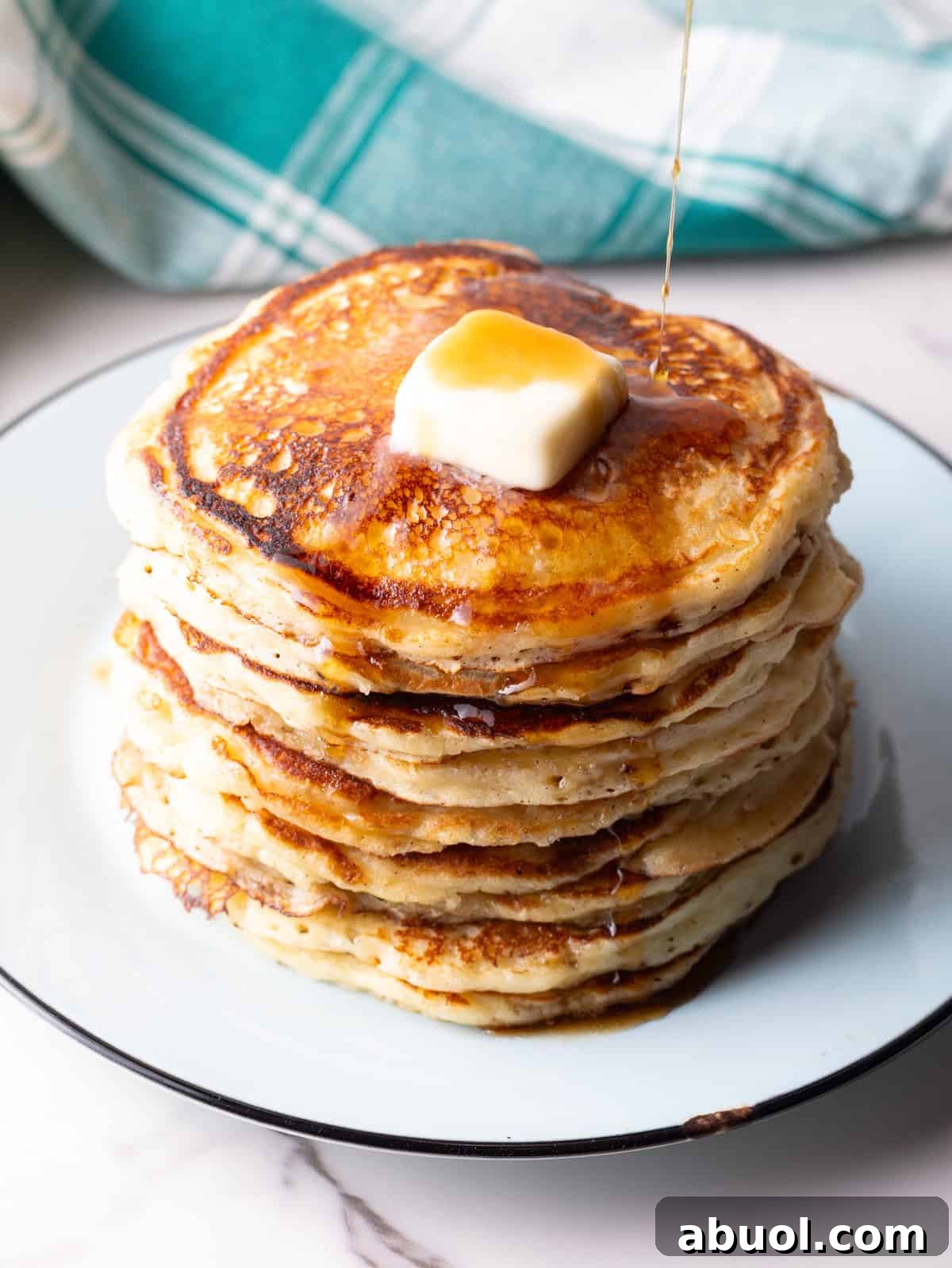 easy buttermilk pancakes with maple syrup poured over the top.