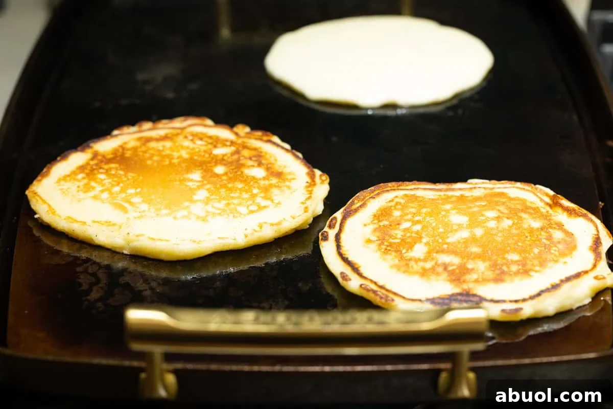 buttermilk pancakes on a hot buttered griddle