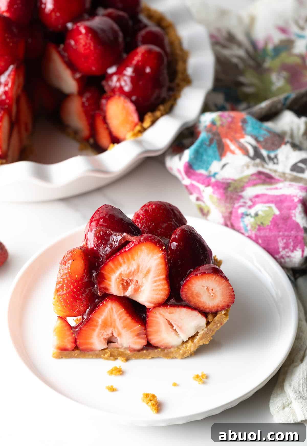 Slice of strawberry pie on a white plate.