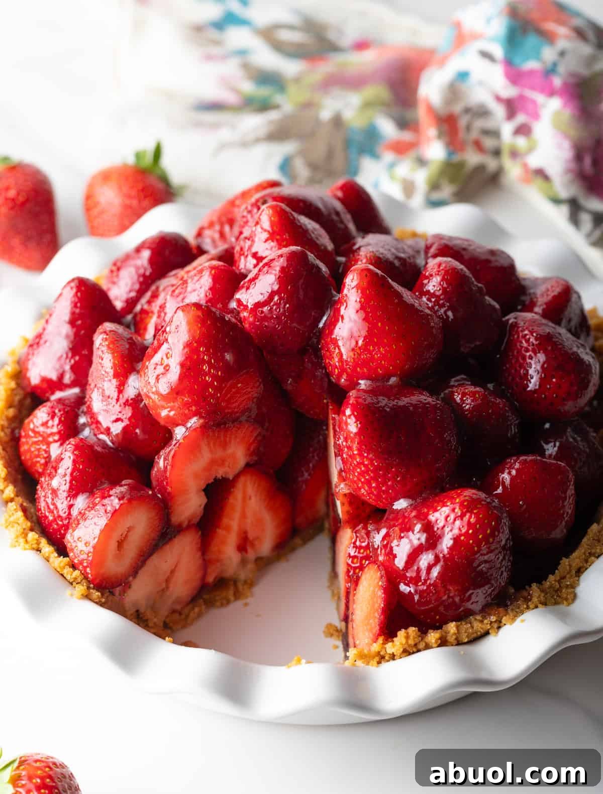 Strawberry pie in a plate, with one slice removed.