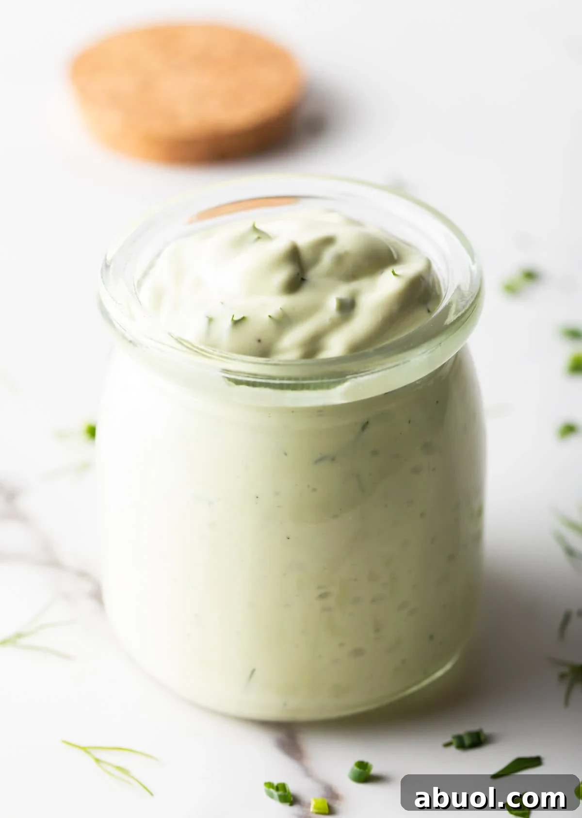 Creamy Avocado Lime Ranch Dressing Recipe 3 A glass jar filled with copycat Chick Fil A avocado lime ranch dressing.