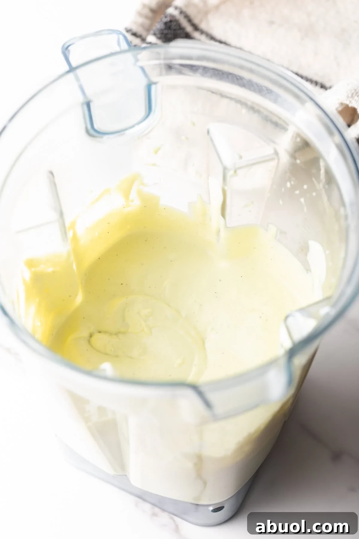 Creamy Avocado Lime Ranch Dressing Recipe 7 An avocado lime ranch dressing recipe is being made in a blender.
