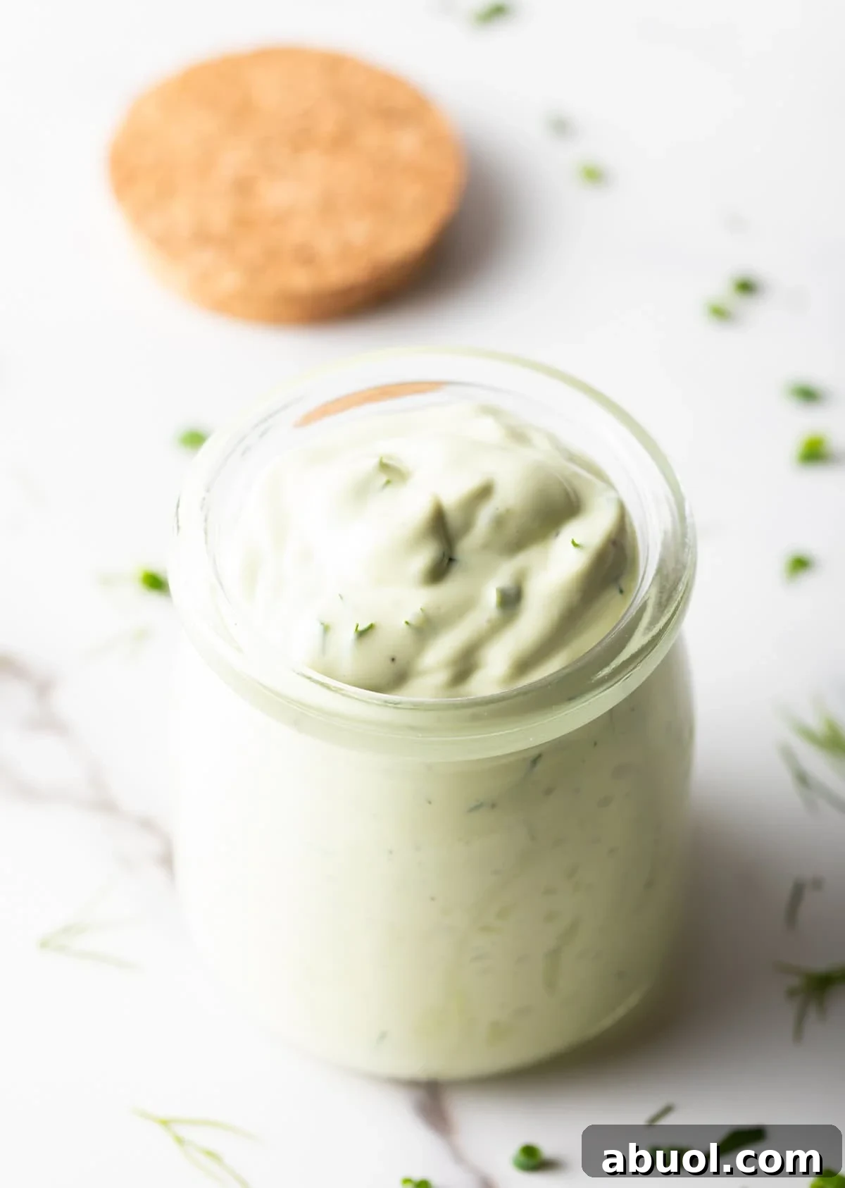 Creamy Avocado Lime Ranch Dressing Recipe 9 Glass jar of green creamy dressing.