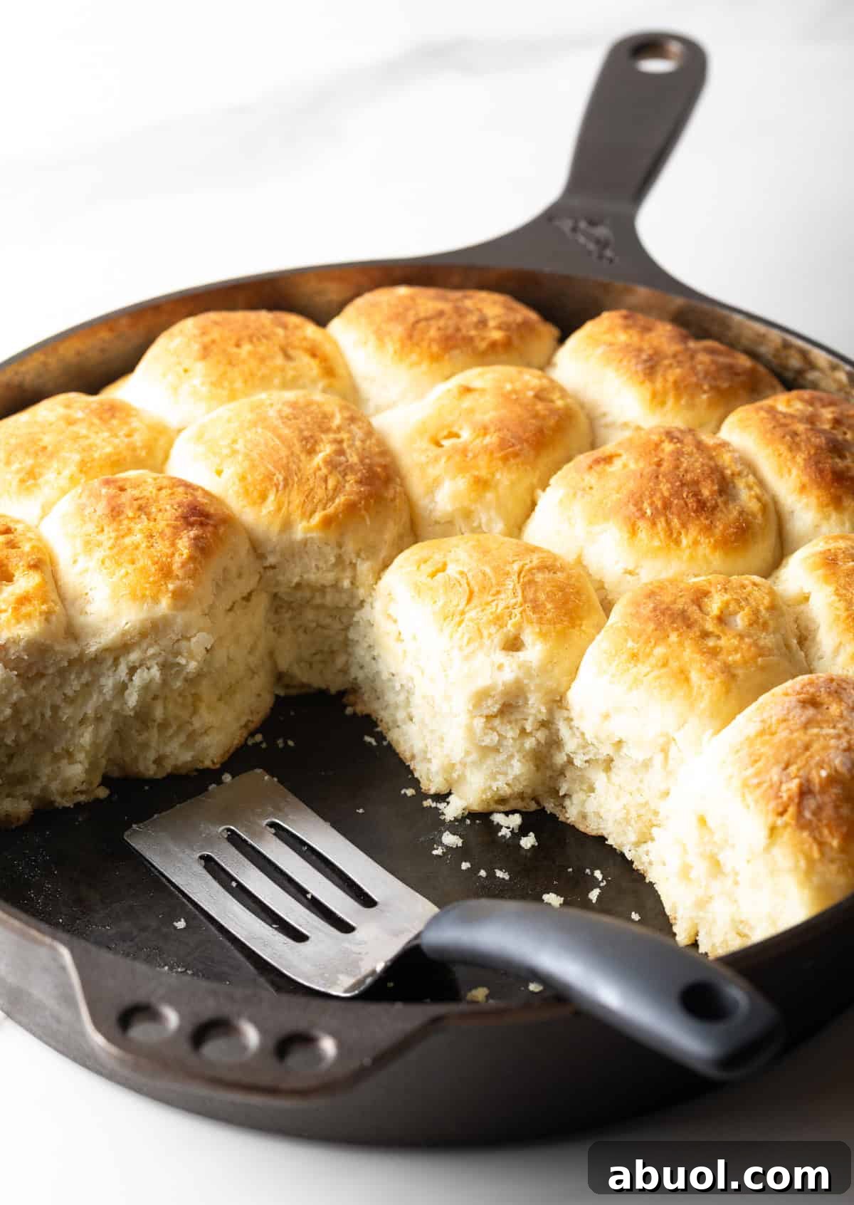 A black skillet filled with an old-fashioned yeast biscuits recipe.