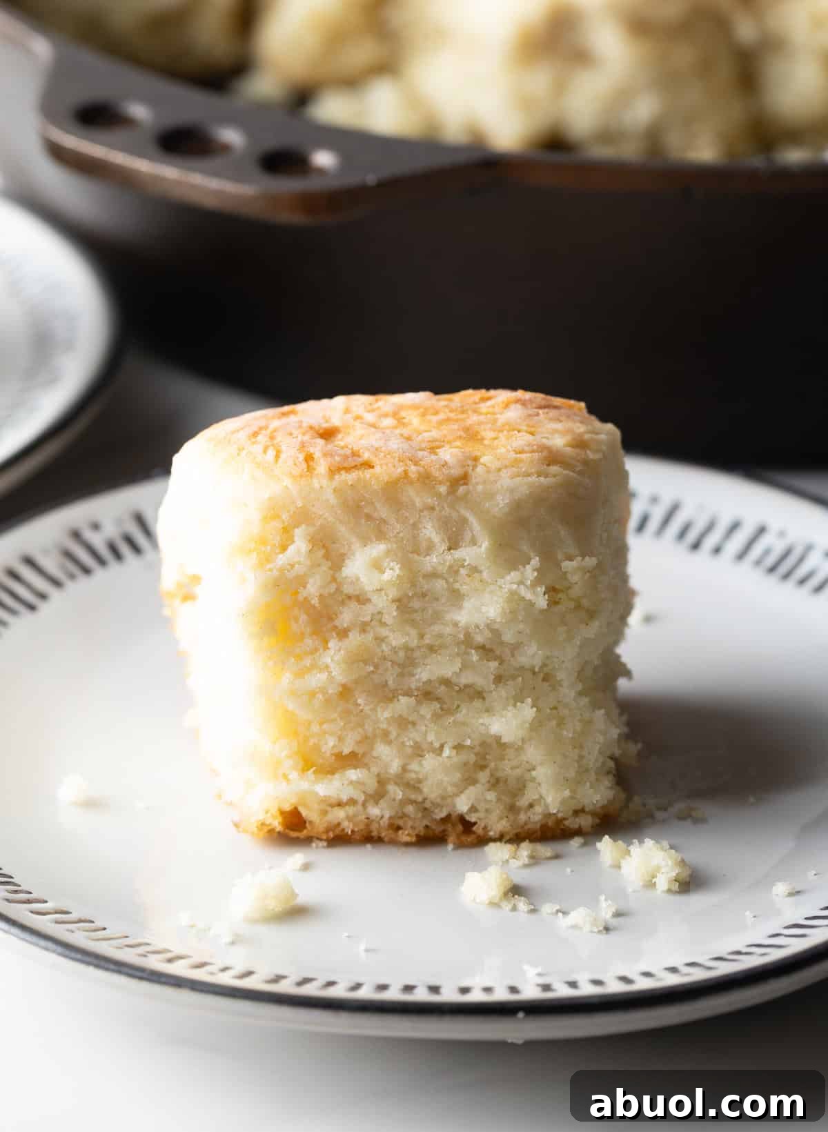 A fluffy angel biscuit sitting on a white plate.
