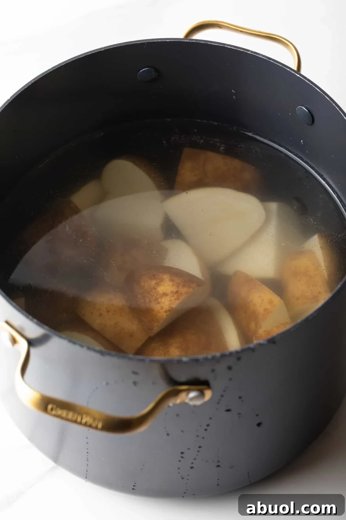 Potato pieces are in a pot of water, ready for boiling.