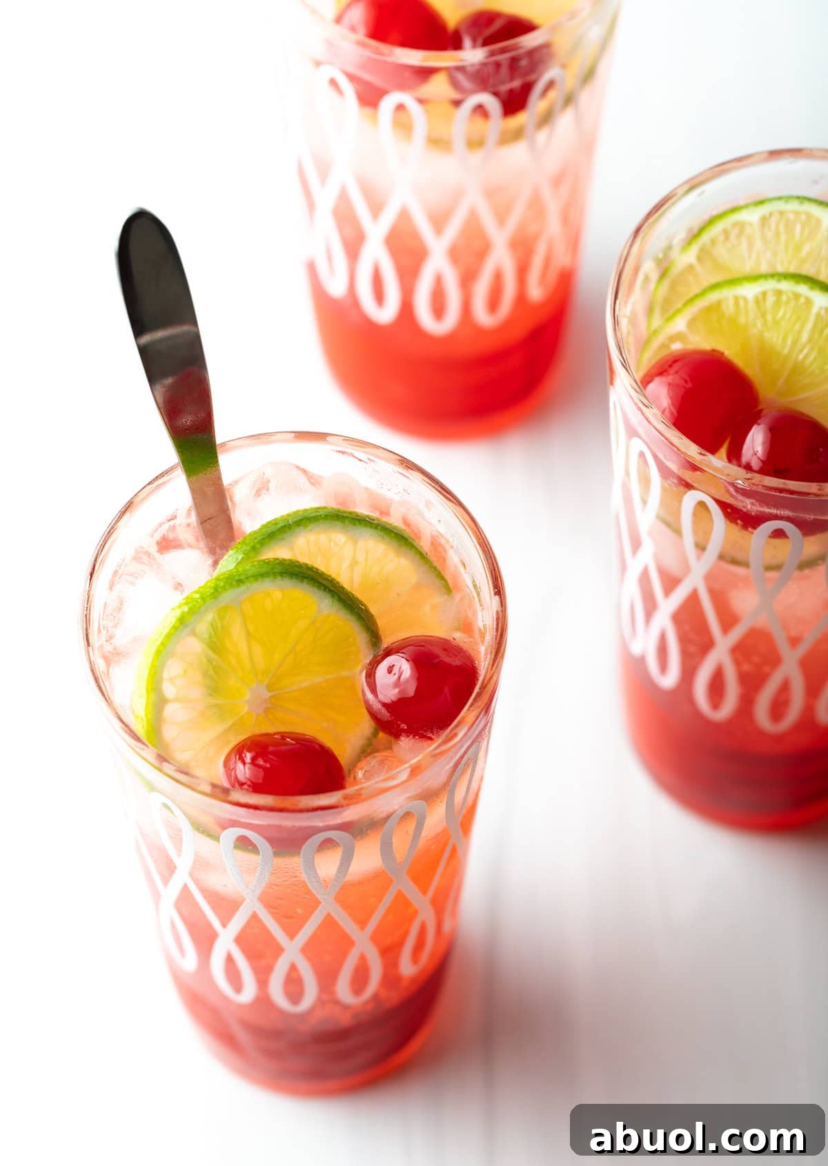 An overhead shot of three glasses of a 3-ingredient cherry limeade recipe.