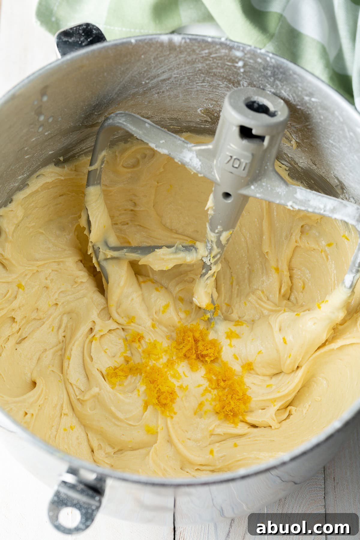 A blueberry muffin recipe mixture is being mixed in a stand mixer.